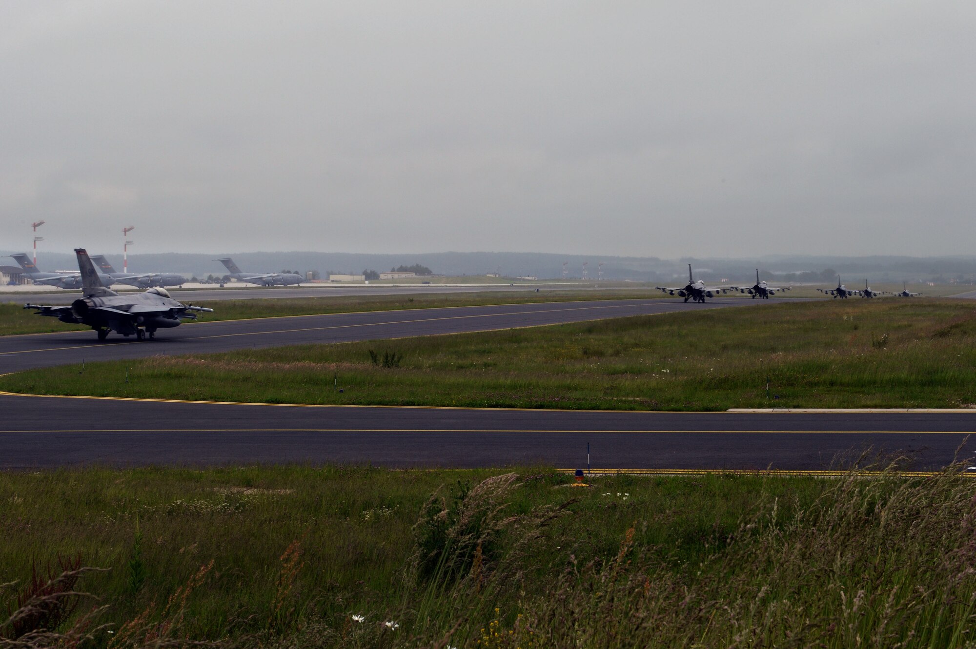 U.S. Air Force F-16 Fighter Falcon fighter aircraft taxi down the runway on Spangdahlem Air Base, Germany, before departing for the U.S. Air Force Aviation Detachment, Poland,  May 30, 2014. This is the fourth fighter aircraft and seventh overall rotation the Av-Det has hosted. (U.S. Air Force photo by Senior Airman Alexis Siekert/Released)  