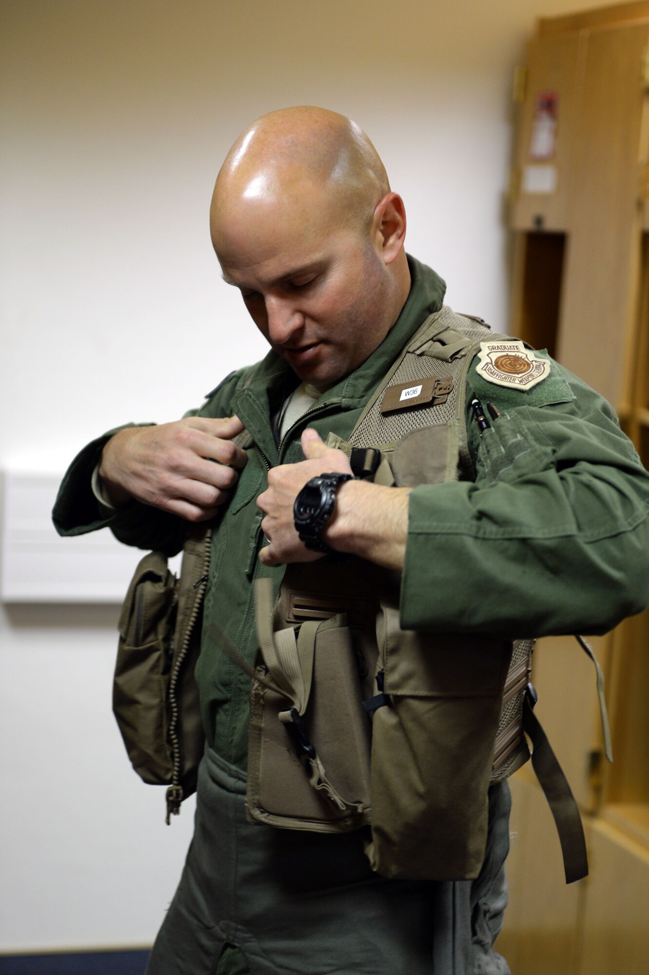 U.S. Air Force Lt. Col. Dave Berkland, 480th Fighter Squadron commander from San Antonio, dons his flight gear before stepping out to a U.S. Air Force F-16 Fighting Falcon fighter aircraft to fly to the U.S. Air Force Aviation Detachment, Poland, from Spangdahlem Air Base, Germany, May 30, 2014. In addition to the 480th FS, the 606th Air Control Squadron will participate in Av-Det Rotation 14-3.  (U.S. Air Force photo by Senior Airman Alexis Siekert/Released)