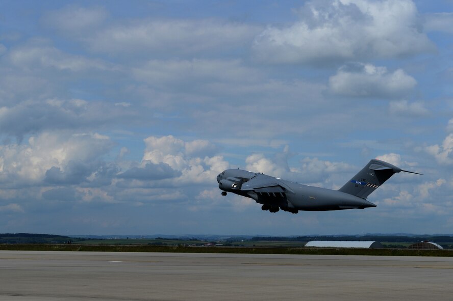 A NATO C-17 Globemaster III cargo aircraft departs Spangdahlem Air Base, Germany, on its way to the U.S. Air Force Aviation Detachment, Poland, May 29, 2014, for the fourth scheduled rotation this fiscal year. Airmen from the 480th Fighter Squadron and 606th Air Control Squadron will be supporting this rotation as well as exercise Baltic Operations 2014. (U.S. Air Force photo by Senior Airman Alexis Siekert/Released)