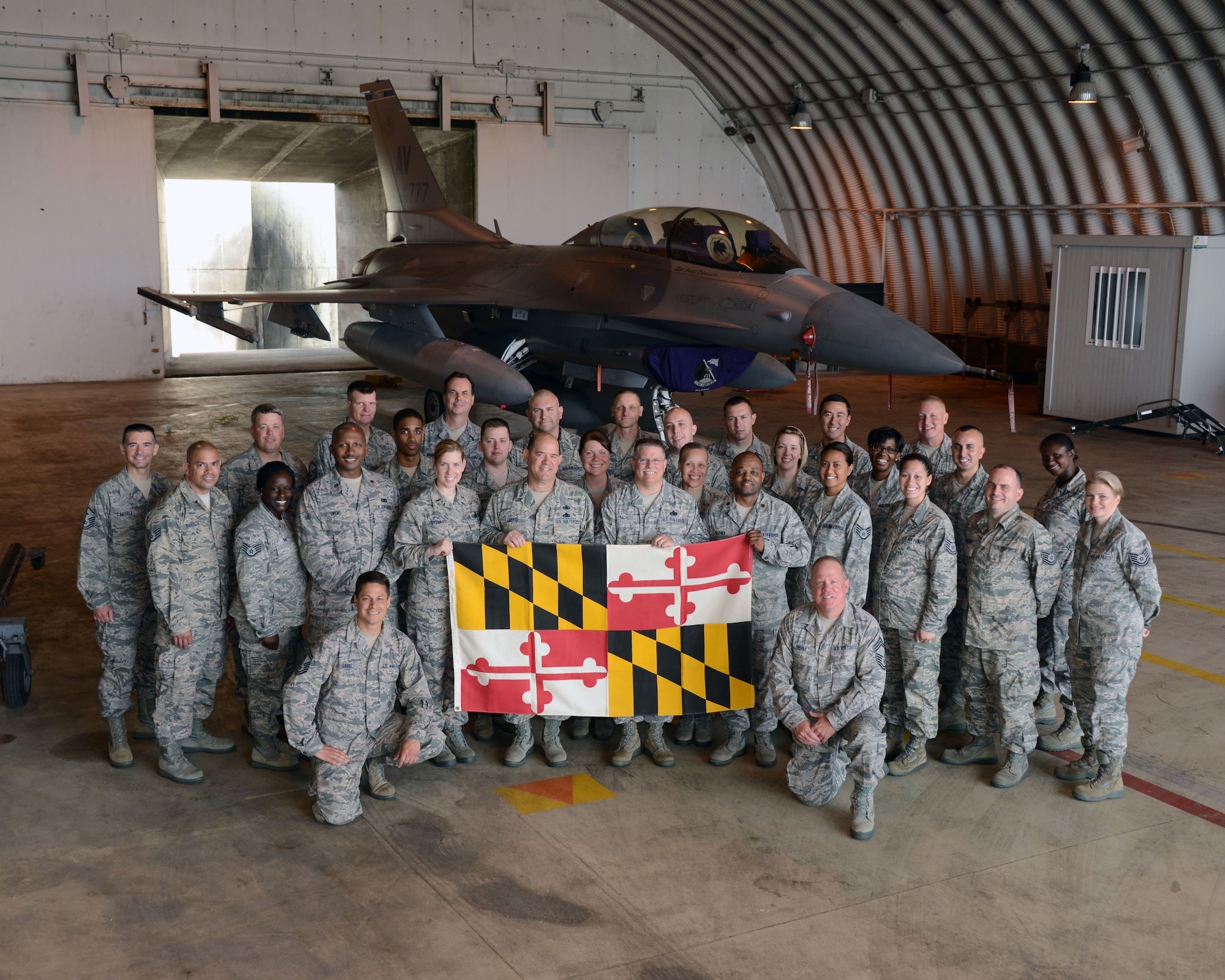 Members of the 175th Logistics Readiness Squadron pose in front of an F-16 Fighting Falcon during their annual training at Aviano Air Base, Italy, May 30, 2014. Nearly 50 members of the Maryland Air National Guard deployed to Italy to train with their active duty counterparts. (National Guard photo by 2nd Lt. Benjamin Hughes/Released)