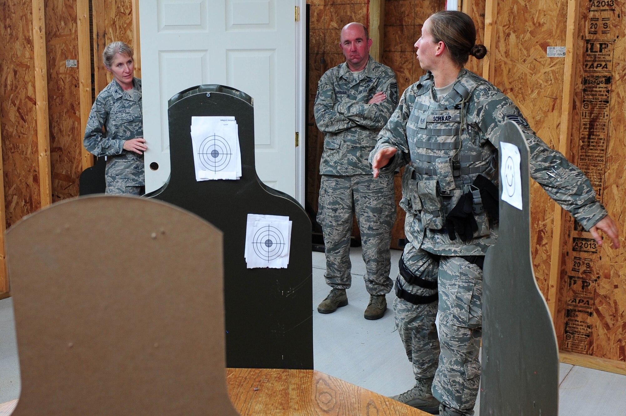 Staff Sgt. Rachel Schaap, 4th Security Forces Squadron unit trainer, explains room clearing tactics to Col. Jeannie Leavitt, 4th Fighter Wing commander and Chief Master Sgt. Jeffery Craver, 4th FW command chief, after a training demonstration, May 30, 2014, at Seymour Johnson Air Force Base, North Carolina. Leavitt and Craver visited the 4th SFS to view their combat readiness, daily operations and participate in a training exercise. (U.S. Air Force photo/Senior Airman John Nieves Camacho)