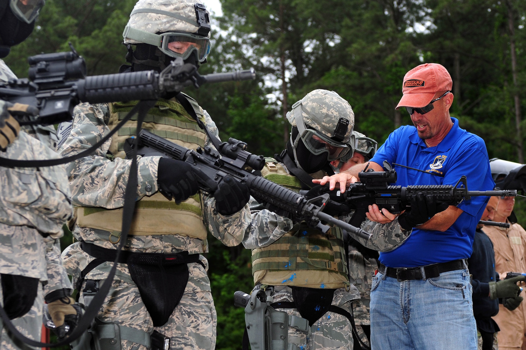 Andy Anderson, 4th Security Forces Squadron law enforcement instructor, assists Col. Jeannie Leavitt, 4th Fighter Wing commander with handling an M4 carbine, May 30, 2014, at Seymour Johnson Air Force Base, North Carolina. 4th SFS Airmen train to hone their combat skills and tactics to prepare for operations overseas. (U.S. Air Force photo/Senior Airman John Nieves Camacho)