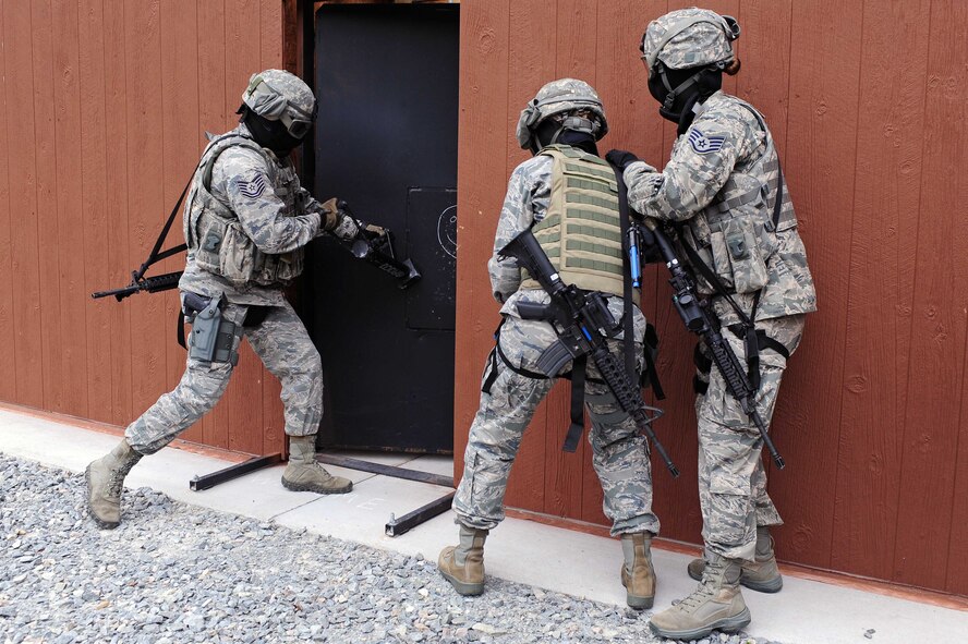 Tech. Sgt. Smith, 4th Security Forces Squadron NCO in-charge of training, breaches a door during a training demonstration, May 30, 2014, Seymour Johnson Air Force Base, North Carolina. 4th SFS Airmen train to hone their combat skills and tactics to prepare for operations overseas. (U.S. Air Force photo/Senior Airman John Nieves Camacho)