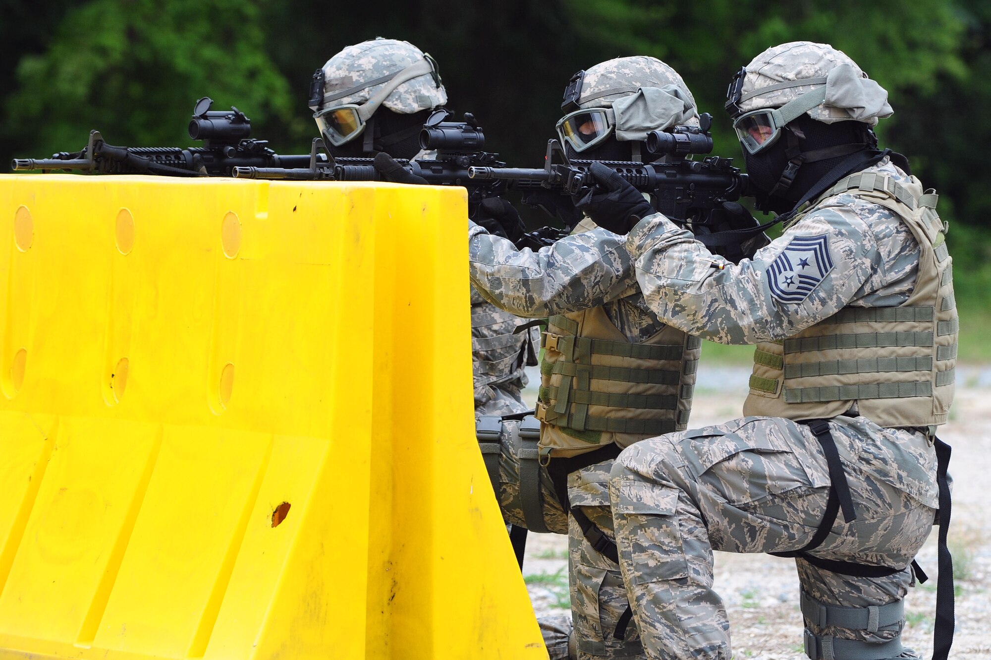 Staff Sgt. Rachel Schaap, left, 4th Security Forces Squadron unit trainer, Chief Master Sgt. Jeffery Craver, 4th Fighter Wing command chief, and Col. Jeannie Leavitt, 4th FW commander, acquire targets during a training demonstration, May 30, 2014, at Seymour Johnson Air Force Base, North Carolina. Leavitt and Craver participated in a demonstration where they embedded in a small unit with 4th SFS Airmen to neutralize simulated targets. (U.S. Air Force photo/Senior Airman John Nieves Camacho)