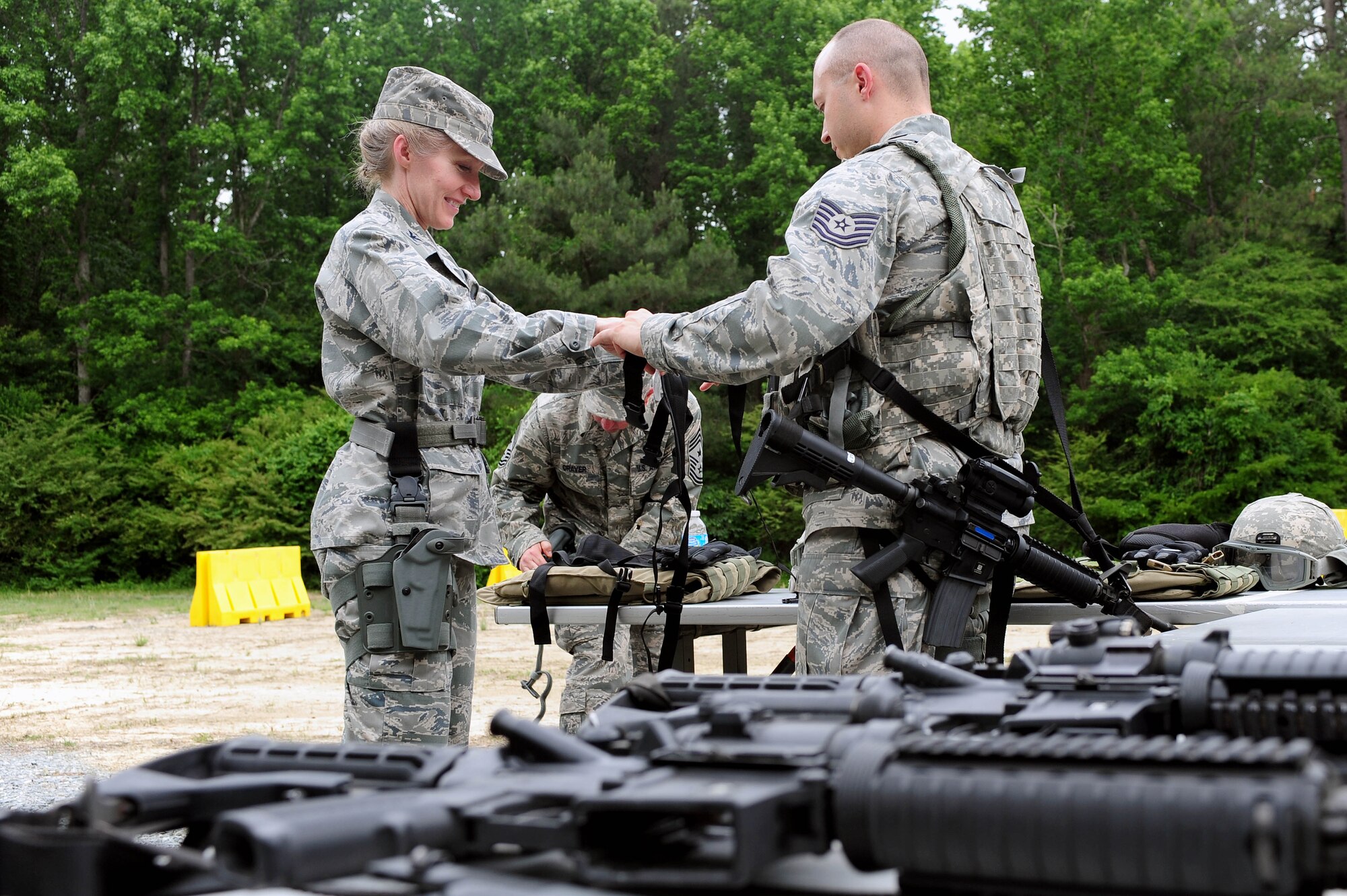 Tech. Sgt. Smith, 4th Security Forces Squadron NCO in-charge of training, prepares Col. Jeannie Leavitt, 4th Fighter Wing commander, prior to a training demonstration, May 30, 2014, at Seymour Johnson Air Force Base, North Carolina. Leavitt will relinquish command June 2, and depart for an assignment at the Pentagon as the principle military assistant to the Secretary of Defense. (U.S. Air Force photo/Senior Airman John Nieves Camacho)
