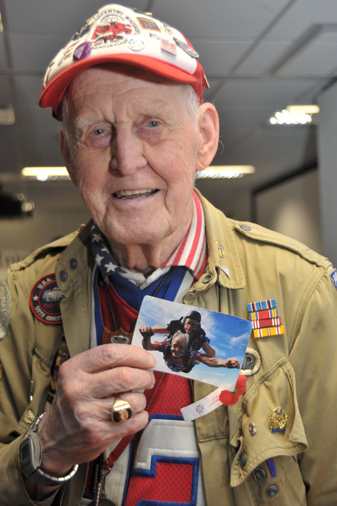 Retired U.S. Army Sgt. Ernie Lamson shows a photo of himself skydiving at the age of 92 during a World War II panel at RAF Molesworth, United Kingdom May 27, 2014. Lamson was assigned to the 508th Parachute infantry Regiment, 82nd Airborne Division in 1942 and served until 1946. (U.S. Air Force photo by Staff Sgt. Ashley Hawkins/Released)
