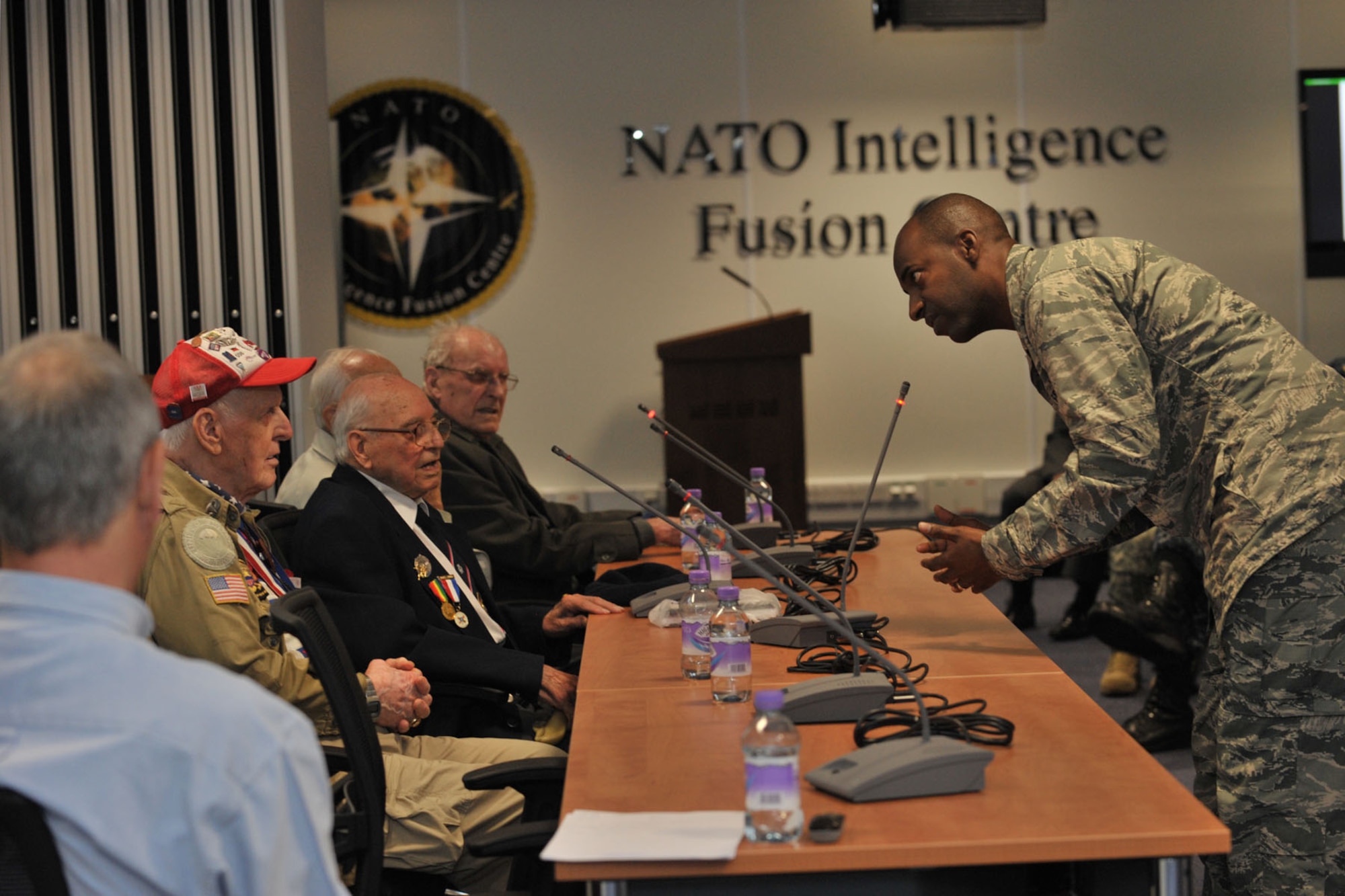 U.S. Air Force Lt. Col. Cornell Burgess, far right, 423rd Force Support Squadron commander, asks United States and United Kingdom World War II veterans questions during a World War II panel at RAF Molesworth, United Kingdom May 27, 2014. In honor of D-Day remembrance, the veterans volunteered to tell their stories and answer questions. (U.S. Air Force photo by Staff Sgt. Ashley Hawkins/Released)