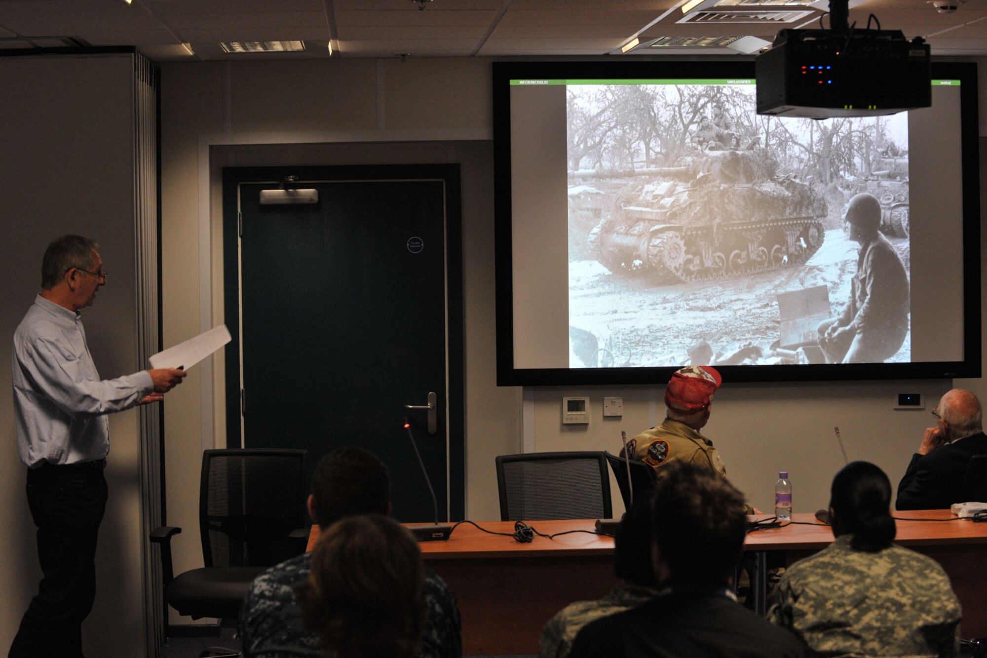 Keith Hill explains the Allied Forces’ combat missions and the weapons used during the D-Day invasion during a World War II panel at RAF Molesworth, United Kingdom May 27, 2014. Hill, whose father is retired “Bevin Boy” Dennis Hill, attended the panel to help facilitate the event and provide historical information about the Allied and Axis Forces’ tactics and machinery. (U.S. Air Force photo by Staff Sgt. Ashley Hawkins/Released)
