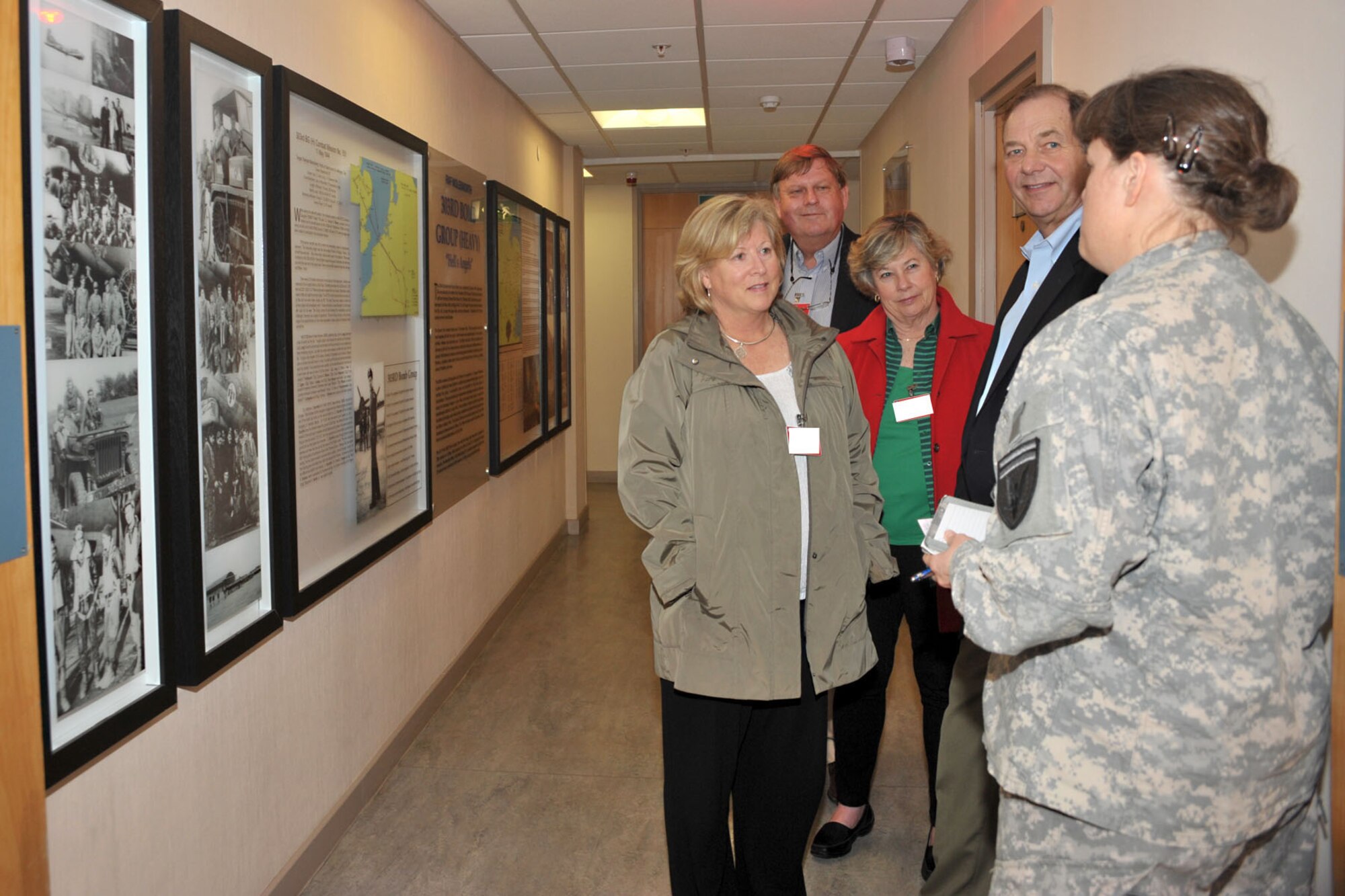 U.S. Army Col. Elizabeth Coble, far right, U.S. European Command J2 reserve management chief, explains the history of the 303rd Bombardment Group’s aerial missions to family members of the late 2nd Lt. Jackson Palmer Jr., World War II 303rd BG navigator, during their visit to RAF Molesworth, United Kingdom April 28, 2014. The second cousins of Palmer, who was killed in action during an aerial mission in 1944, initially knew nothing of his life or where he was laid to rest and visited the base after finding information about him online.  (U.S. Air Force photo by Staff Sgt. Ashley Hawkins/Released)