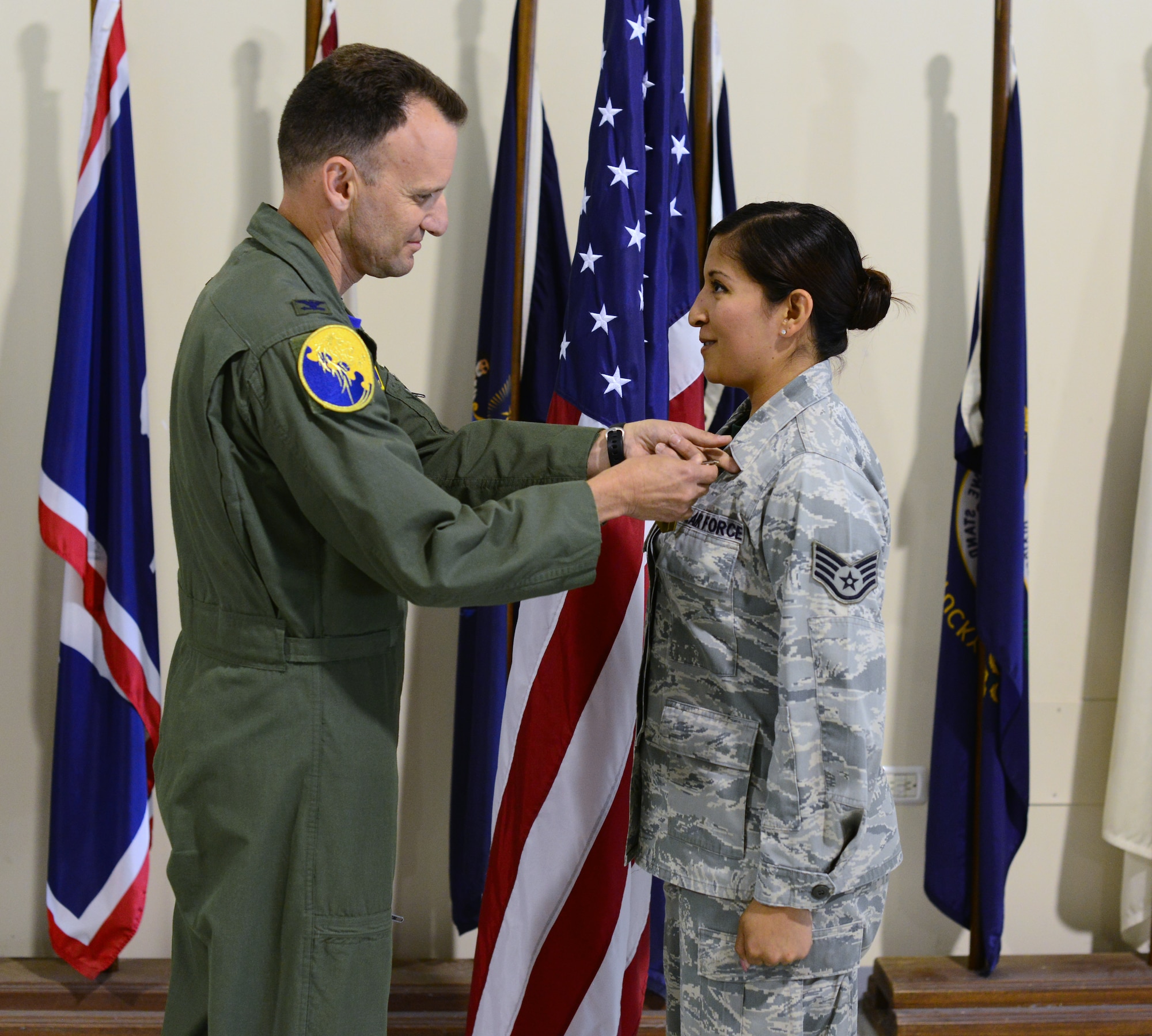 Col. Anthony Abernathy, 31st Operations Group commander, presents Staff Sgt. Xanadu Moldenhauer, 555th Fighter Squadron knowledge operator, with the Air Force Commendation Medal, May 30, 2014, at Aviano Air Base, Italy. Moldenhauser was recognized for saving the life of Staff Sgt. Travis Brown, former 31st Munitions Squadron, armament training monitor. (U.S. Air Force photo/Senior Airman Michael Battles)