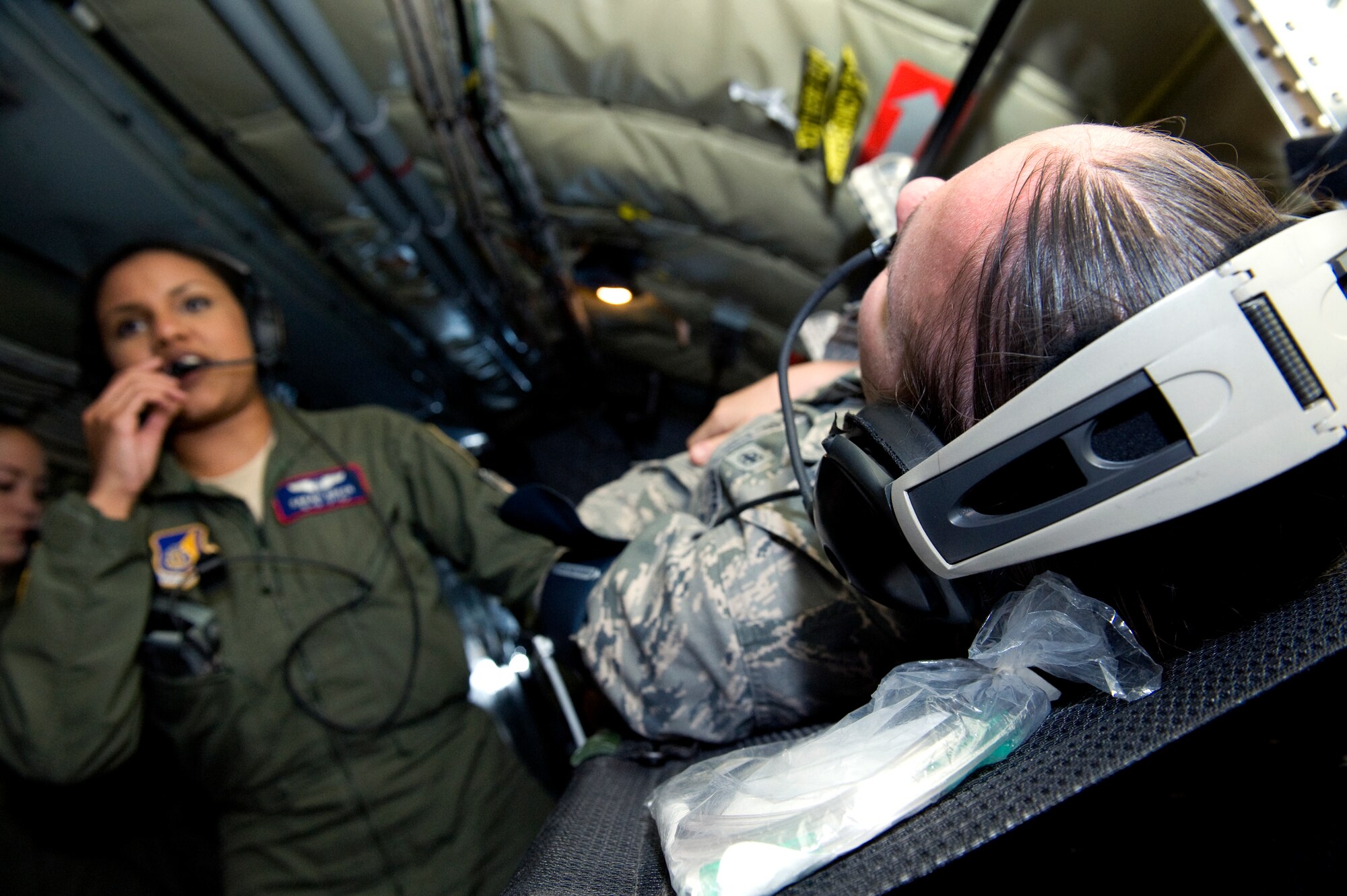 U.S. Air Force 1st Lt. Sarah Green, 18th Aeromedical Evacuation Squadron flight nurse, communicates to evaluators during a casualty training scenario while onboard a 909th Air Refueling Squadron KC-135 Stratotanker stationed at Kadena Air Base, Japan, May 19, 2014. The 18th AES conducts aerial patient transportation training at least once a week to ensure each nurse and technician remains proficient and prepared for potential real-world scenarios. (U.S. Air Force photo by Senior Airman Maeson L. Elleman)