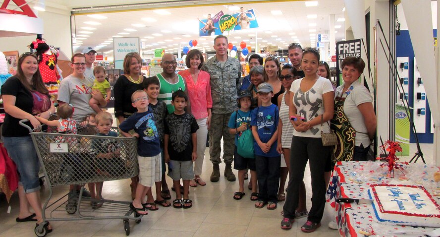 36th Wing commander Brig. Gen. Steven Garland poses with military spouses during the Military Spouse Application Day event at the Base Exchange on Andersen Air Force Base, Guam May 17, 2014. The 36th Wing Airman and Family Readiness Center hosted 15 helping agencies, who provided information tables to support more than 200 military spouses during the event. (Courtesy photo/Released)