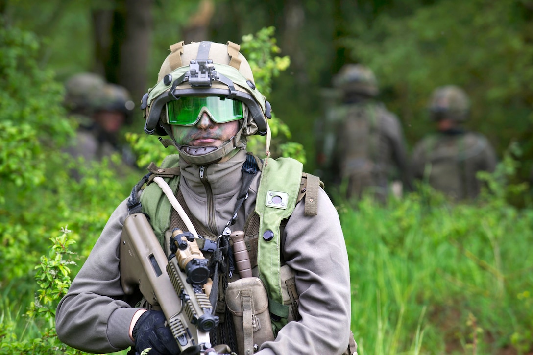 An Austrian soldier provides security on a patrolling exercise while being observed by U.S. Army observer controllers during Exercise Combined Resolve II at the Joint Multinational Readiness Center in Hohenfels, Germany, May 19, 2014.
