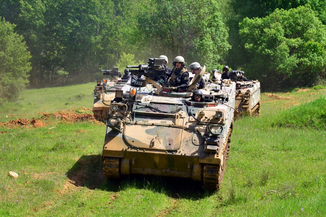 U.S. soldiers advance on the objective in an M113 armored personnel carrier during Exercise Combined Resolve II at the Joint Multinational Readiness Center in Hohenfels, Germany, May 22, 2014. The soldiers are assigned to the 1st Battalion, 4th Infantry Regiment.