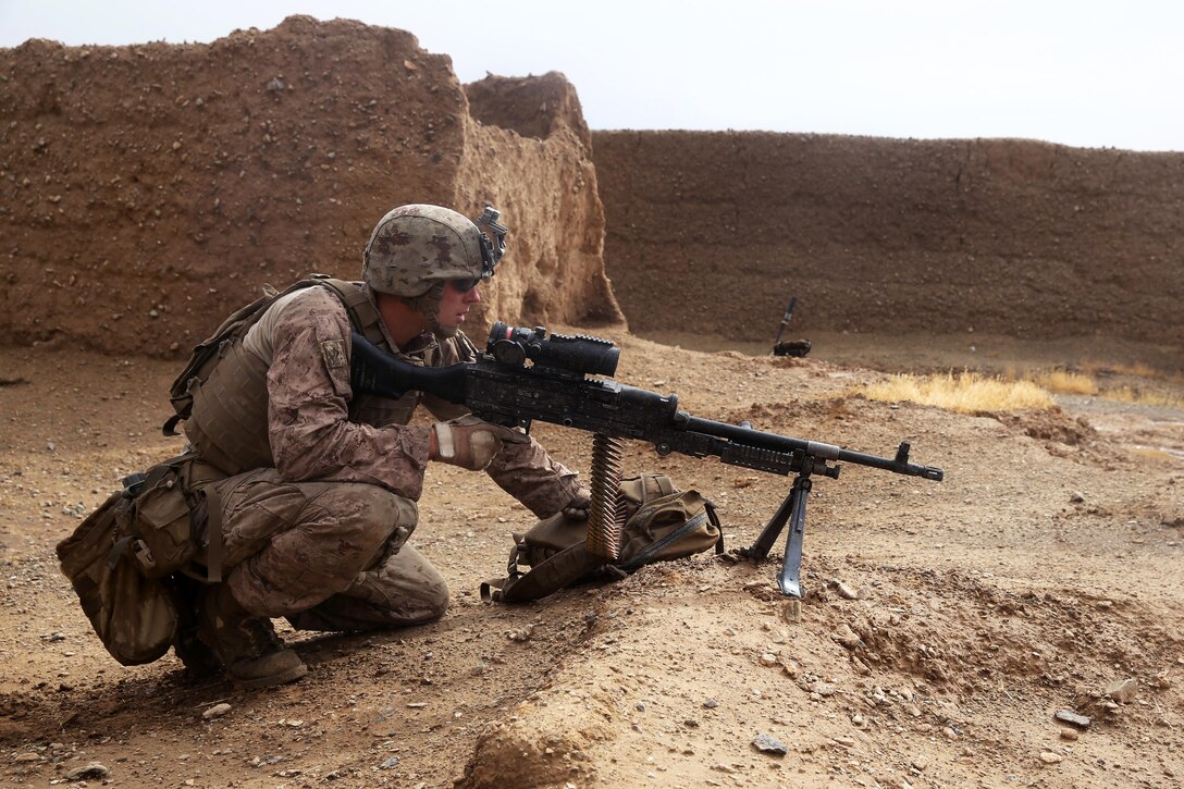 U.S. Marine Corps Lance Cpl. Cody Kelley provides security with an M240B medium machine gun during a mission in Larr village in Helmand province, Afghanistan, May 15, 2014. Kelley, a machine gunner, is assigned to Bravo Company, 1st Battalion, 7th Marine Regiment.