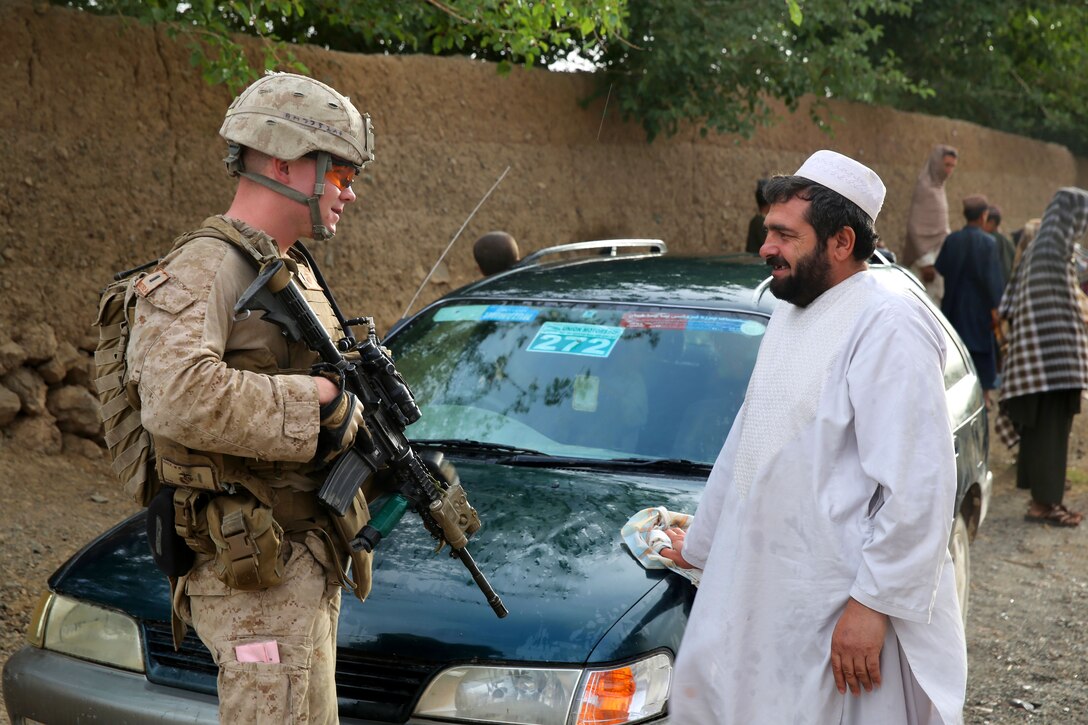 U.S. Marine Corps 1st. Lt. Walter Mack, left, speaks with an Afghan man during a mission in Larr village in Helmand province, Afghanistan, May 15, 2014. Mack, an executive officer, is assigned to Bravo Company, 1st Battalion, 7th Marine Regiment.
