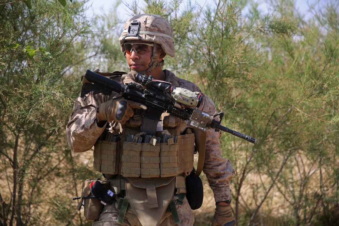 U.S. Marine Corps Corporal Isaac Garcia provides security during a ...