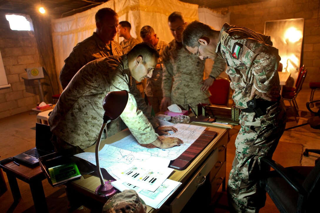 U.S. Marine Corps Lt. Col. David Sosa and Jordanian army Lt. Sol. Saif study a map of a training area in Jabal, Petra, Jordan, May 15, 2012, to prepare for Exercise Eager Lion 2012. Sosal is the commanding officer of 1st Battalion, 2nd Marine Regiment, 24th Marine Expeditionary Unit, and Saif is the commander of Jordan's 4th Tank Battalion.  
