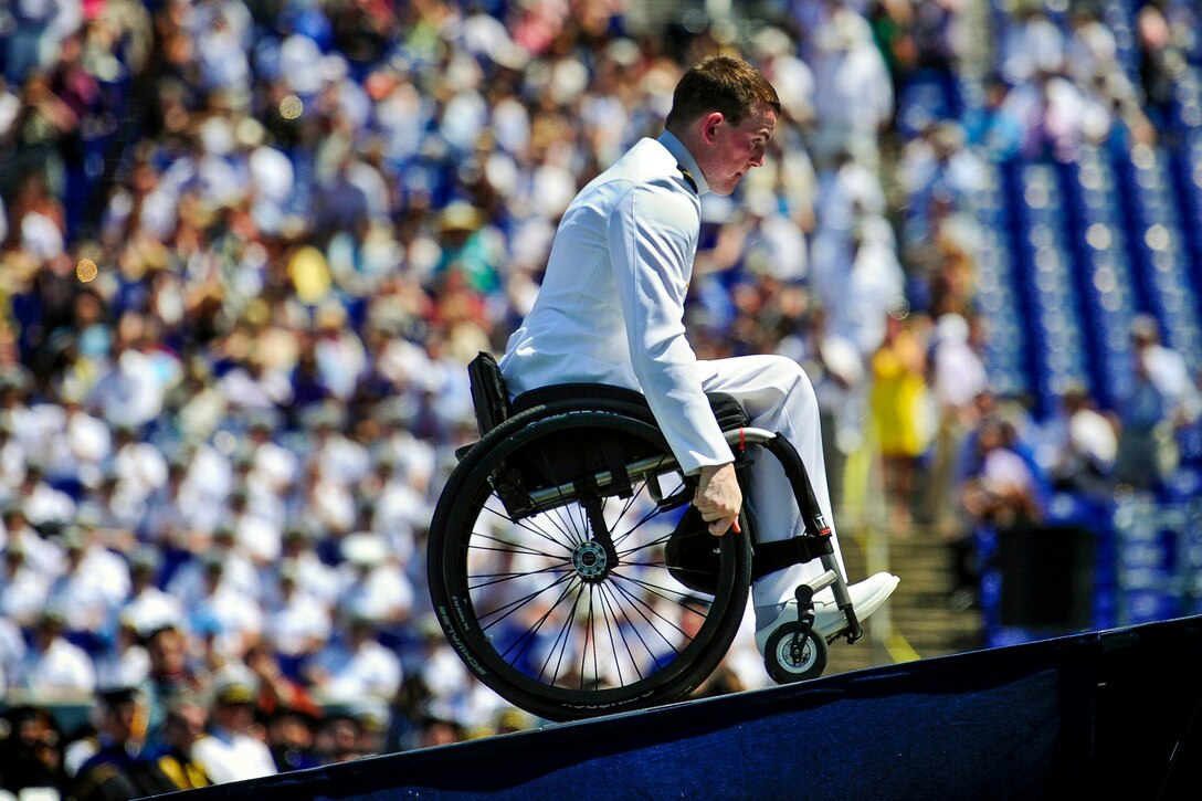 Navy Petty Officer 1st Class Kevin Hillery makes his way on stage to receive his diploma during the 2012 graduation ceremony at the U.S. Naval Academy in Annapolis, Md., May 29, 2012. Despite an accident in April that left him paralyzed, Hillery graduated from the academy.  

