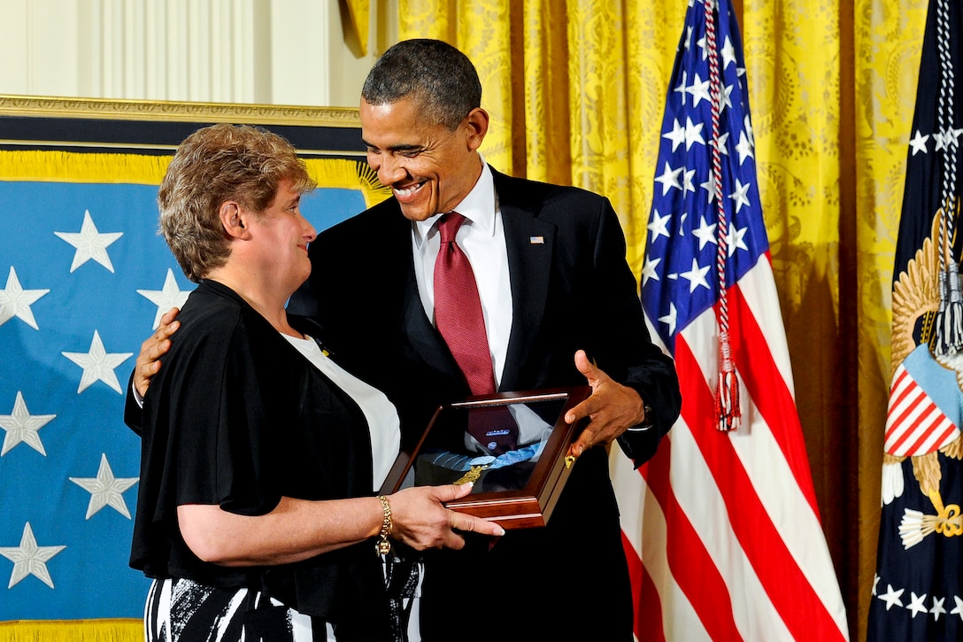 President Barack Obama awards the Medal of Honor posthumously to Army Spc. 4 Leslie H. Sabo Jr. and presents it to Sabo's widow, Rose Mary Sabo-Brown, during a ceremony at the White House in Washington, D.C., May 16, 2012. Sabo was killed in action in Cambodia in 1970 while saving the lives of fellow soldiers during the Vietnam War.  
