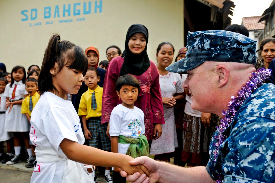 U.S.Navy Chief Warrant Officer Jody Olson greets an Indonesian girl at Yayasan Pendidikan Banglin school during a community service event in Jakarta, Indonesia, May 14, 2012. Port visits represent an opportunity for U.S. 7th Fleet flagship USS Blue Ridge crewmembers to serve as goodwill ambassadors, promoting peace and stability in the region and demonstrating their commitment to regional partnerships.  
