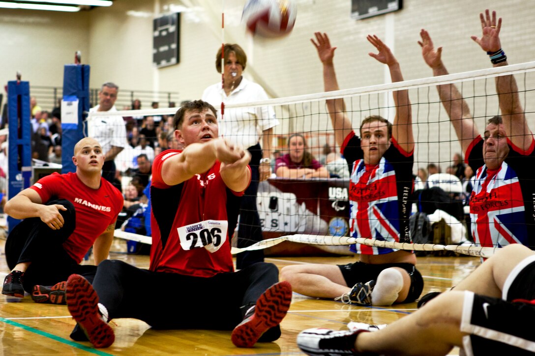 Marine Corps Sgt. Stephen K. Lunt bumps the ball to a teammate as the all-Marine team plays the United Kingdom team in a sitting volleyball match during the 2012 Warrior Games at the U.S. Air Force Academy in Colorado Springs, Colo., May 2, 2012. The undefeated Marines won the match in two games, continuing their 3-0 winning streak.  
