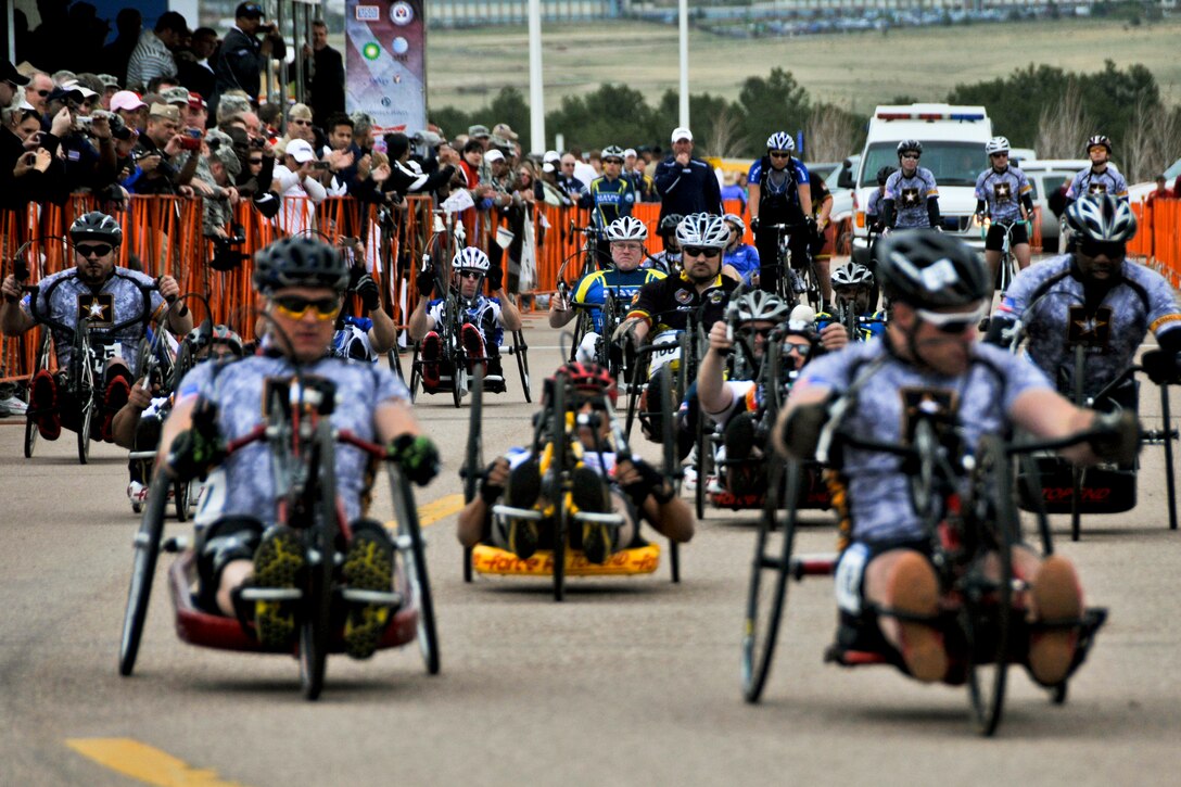 Army competitors rush forward from the starting line as they compete in the men's handcycle 10K during the first day of the 2012 Warrior Games in Colorado Springs, Colo., May 1, 2012. The Army won first and third places in the race.  

