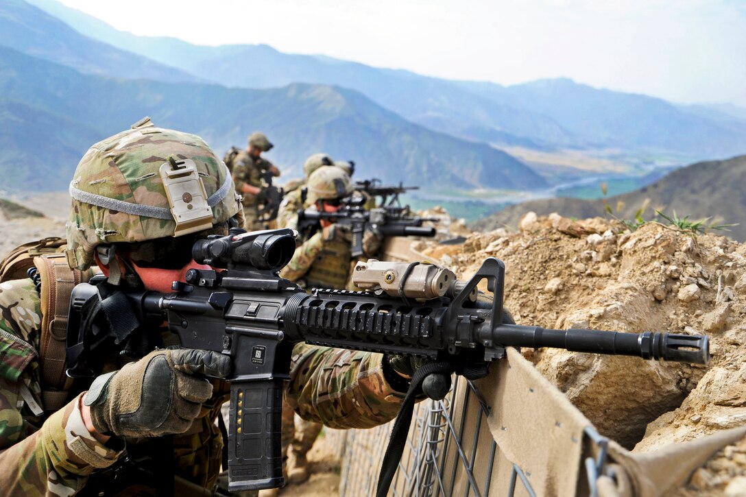 U.S. Army Spc. Timothy Shout uses his weapon's scope to scan the nearby ridge following an engagement with anti-Afghan forces on Forward Operating Base Wright in Afghanistan's Kunar province, April 19, 2012. Shout is assigned to the Provincial Reconstruction Team Kunar security forces. The unit took small-arms fire during a routine patrol and suppressed the enemy with the assistance from Afghan troops.  
