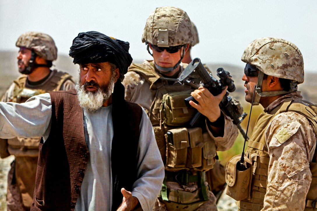 U.S. Marines and an interpreter listen to an Afghan man during a security patrol in Kajaki, Afghanistan, April 14, 2012, as his squad begins a foot patrol. The Marines are assigned to Weapons Company, 1st Battalion, 8th Marine Regiment. 

