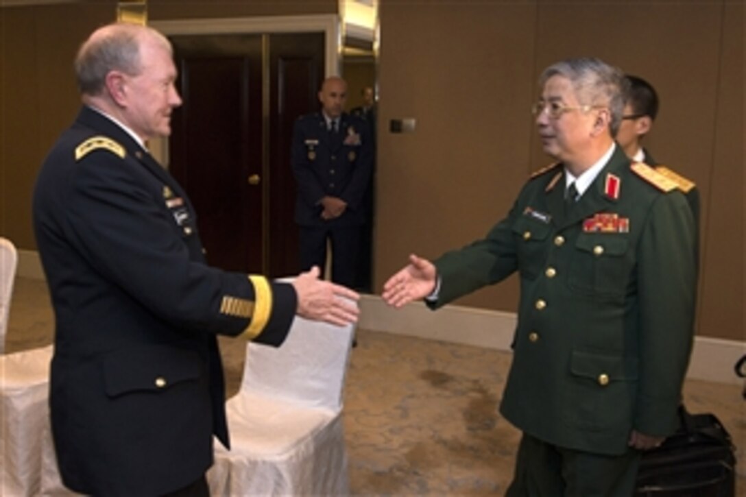 U.S. Army Gen. Martin E. Dempsey, chairman of the Joint Chiefs of Staff, greets Vietnamese Deputy Defense Minister Lt. Gen. Nguyen Chi Vinh during a bilateral meeting at the Shangri-La Dialogue in Singapore, May 31, 2014. 