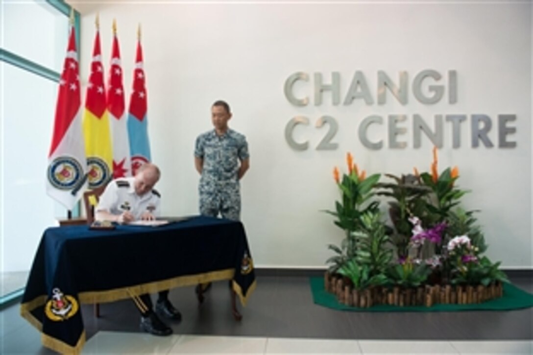 U.S. Army Gen. Martin E. Dempsey, chairman of the Joint Chiefs of Staff, signs a guest book after visiting the Changi Command and Control Center on Changi Naval Base in Singapore, May 31, 2014.