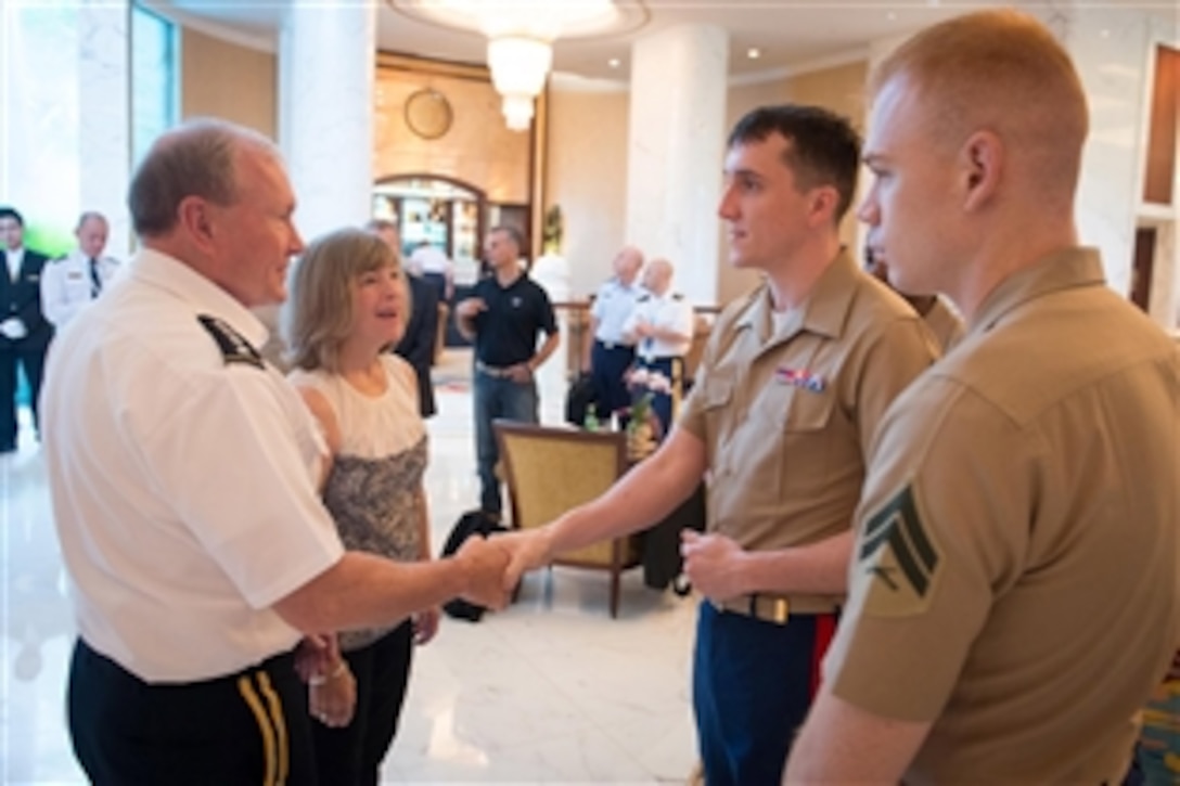 U.S. Army Gen. Martin E. Dempsey, chairman of the Joint Chiefs of Staff, and his wife, Deanie, talk with U.S. Marines while in Singapore, May 31, 2014. 