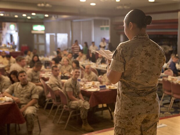 Seaman Colleen Yabut, logistics specialist with Headquarters and Headquarters Squadron, recites a poem in Filipino; her native language. Yabut said being able to recite a poem in her native tongue allowed her to reconnect with her ethnic roots.