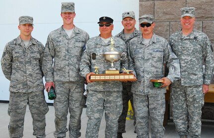 New York Guard Staff Sgt. Joe Dee stands front and center holding the "Sergeant Joe Dee Combined Arms Team Champion" trophy which was presented to a team from the New York Air National Guard's 174th Airlift Wing during the New York National Guard's annual The Adjutant Generals (TAG) Match held May 30-June 1. Dee, who retired from the New York Army National Guard in 2007, currently serves in the New York Guard,the state's volunteer defense force. The award honored his commitment to the New York National Guard marksmanship program. Joining the group is Brig. Gen. Michael Swezey, commander of the 53rd Troop Command.