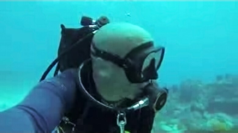 Former Army diver Mark Claudio “at home,” in scuba gear, drifting along Molasses Reef near Key Largo during a vacation in Florida.