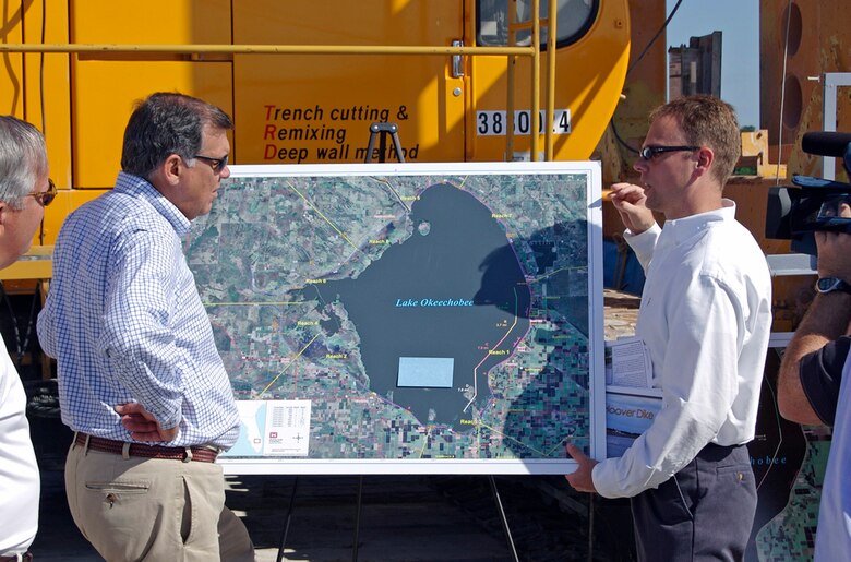 Mike Rogalski, right, briefs then-Senator Mel Martinez about Herbert Hoover Dike and updates him on the Corps' expedited rehabilitation work. At the time, Rogalski served as the Herbert Hoover Dike project manager.