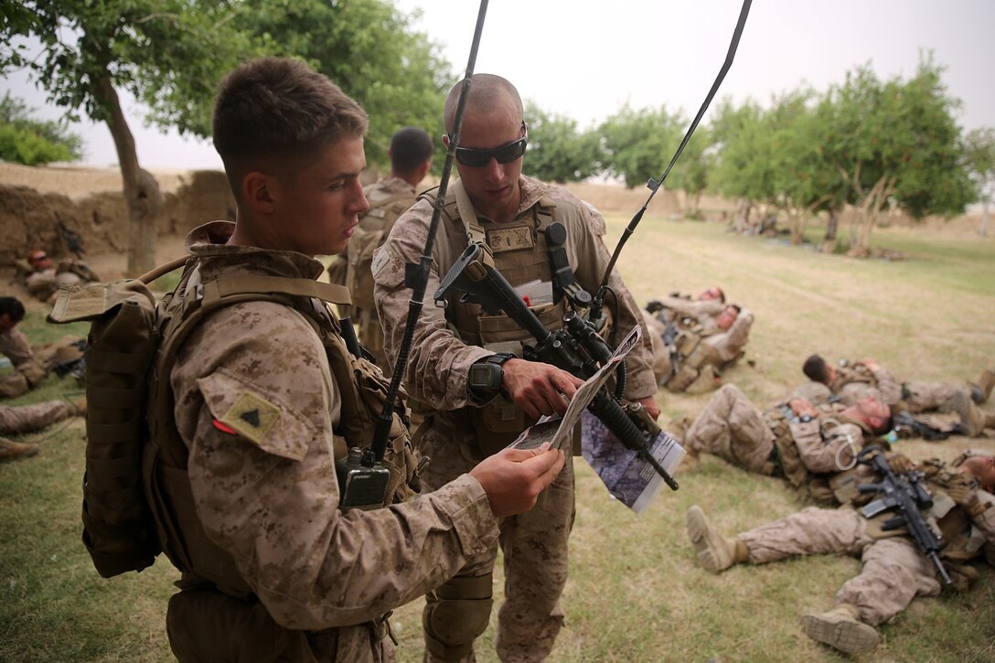 Corporal Dale Sherrill Jr., left, squad leader, Bravo Company, 1st Battalion, 7th Marine Regiment, and 2nd Lt. Zachary Geelan, a platoon commander with the company, review a map before conducting a patrol during a mission in Helmand province, Afghanistan, May 15, 2014. The company operated in Larr Village for two days to establish a presence and to disrupt enemy fighters. Throughout the mission the infantrymen conducted several patrols within the village and discovered hazardous materials which could be used to create improvised explosive devices.
