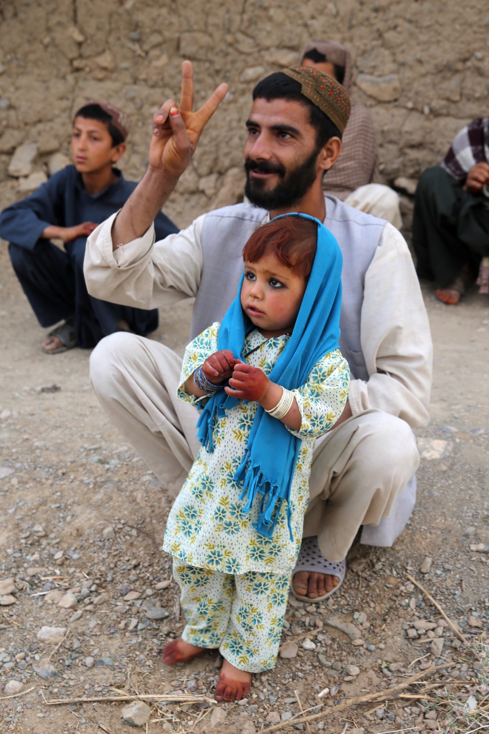 An Afghan local bids farewell to Marines with Bravo Company, 1st Battalion, 7th Marine Regiment, as they depart the area during a mission in Helmand province, Afghanistan, May 15, 2014. The company operated in Larr Village for two days to establish a presence and to disrupt enemy fighters. Throughout the mission the infantrymen conducted several patrols within the village and discovered hazardous materials which could be used to create improvised explosive devices.