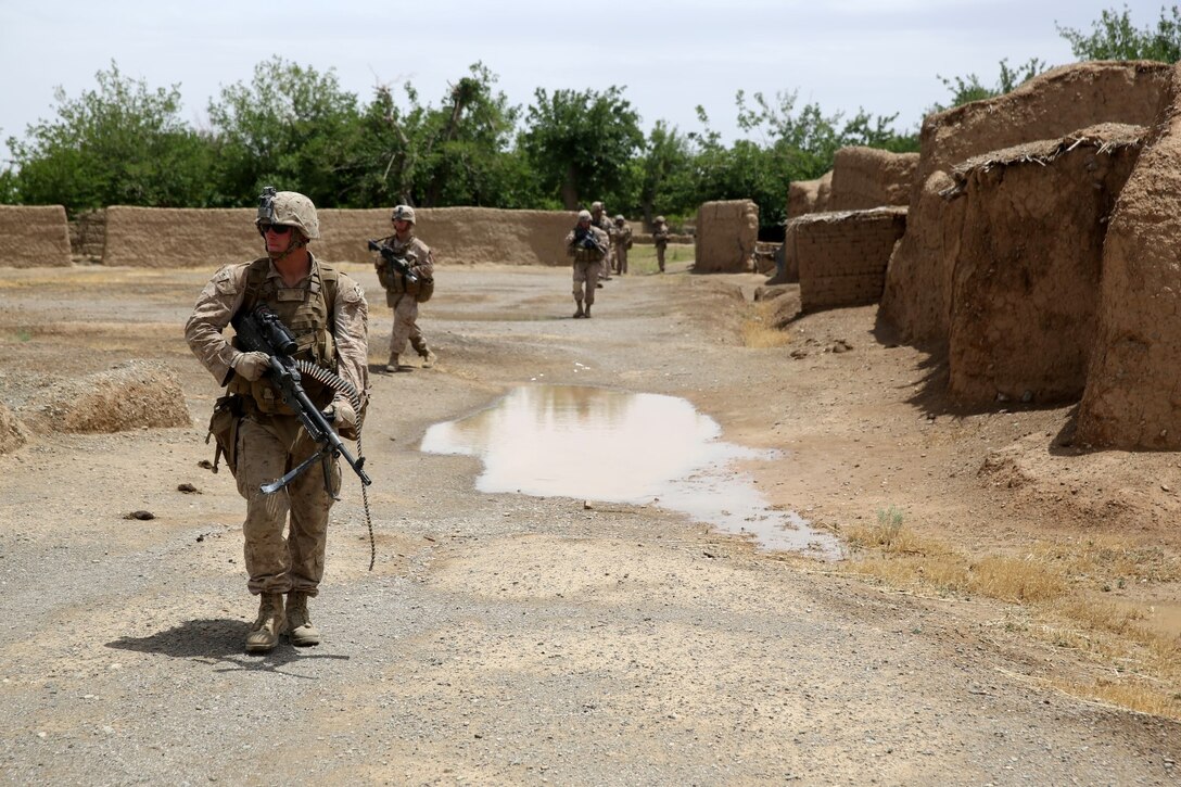 Lance Cpl. Cody Kelley, machine gunner, Bravo Company, 1st Battalion, 7th Marine Regiment, and a native of Midway, Utah, patrols with an M240B medium machine gun during a mission in Helmand province, Afghanistan, May 15, 2014. The company operated in Larr Village for two days to establish a presence and to disrupt enemy fighters. Throughout the mission the infantrymen conducted several patrols within the village and discovered hazardous materials which could be used to create improvised explosive devices.
