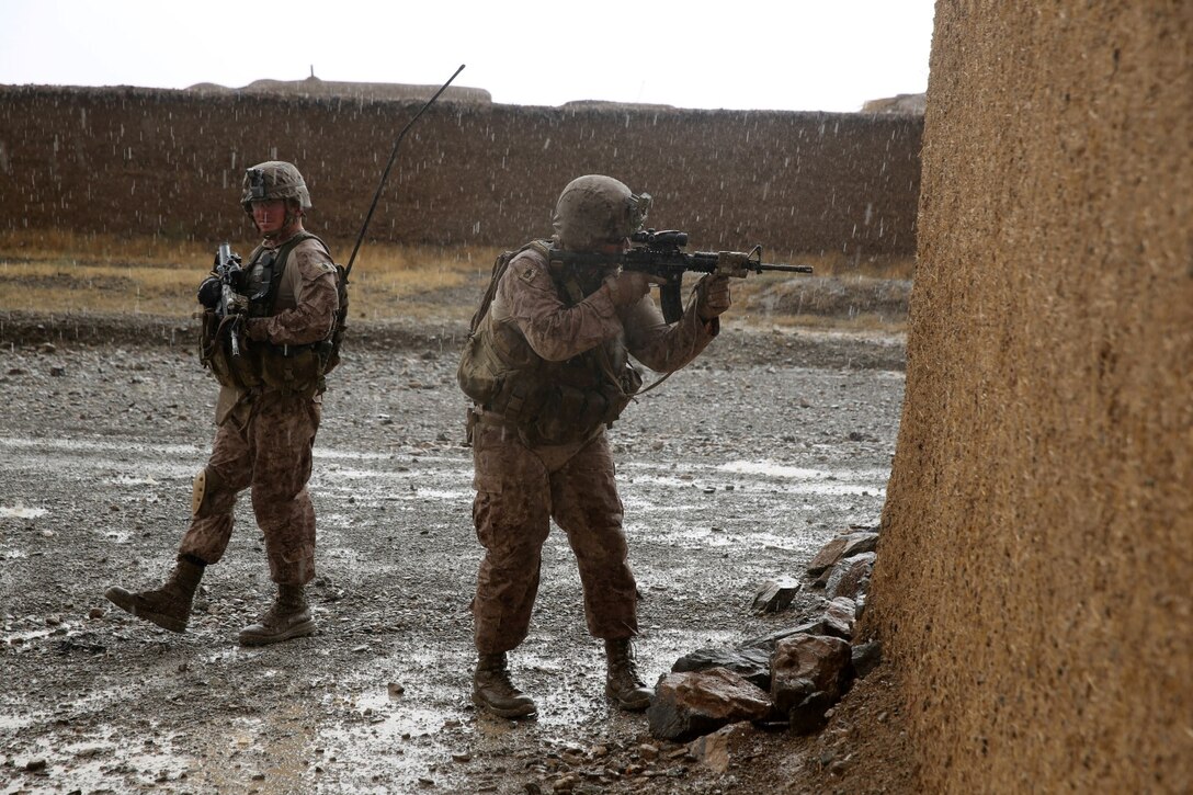Gunnery Sgt. Hector Angulo, right, company gunnery sergeant, Bravo Company, 1st Battalion, 7th Marine Regiment, and Staff Sgt. Matthew Ingwerson, a platoon sergeant with the company, provide security during a mission in Helmand province, Afghanistan, May 15, 2014. The company operated in Larr Village for two days to establish a presence and to disrupt enemy fighters. Throughout the mission the infantrymen conducted several patrols within the village and discovered hazardous materials which could be used to create improvised explosive devices.