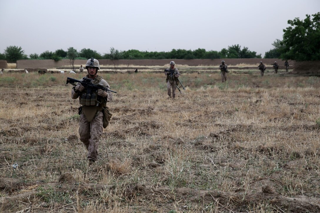 Marines and sailors with Bravo Company, 1st Battalion, 7th Marine Regiment, conduct a final security patrol during a mission in Helmand province, Afghanistan, May 15, 2014. The company operated in Larr Village for two days to establish a presence and to disrupt enemy fighters. Throughout the mission the infantrymen conducted several patrols within the village and discovered hazardous materials which could be used to create improvised explosive devices.