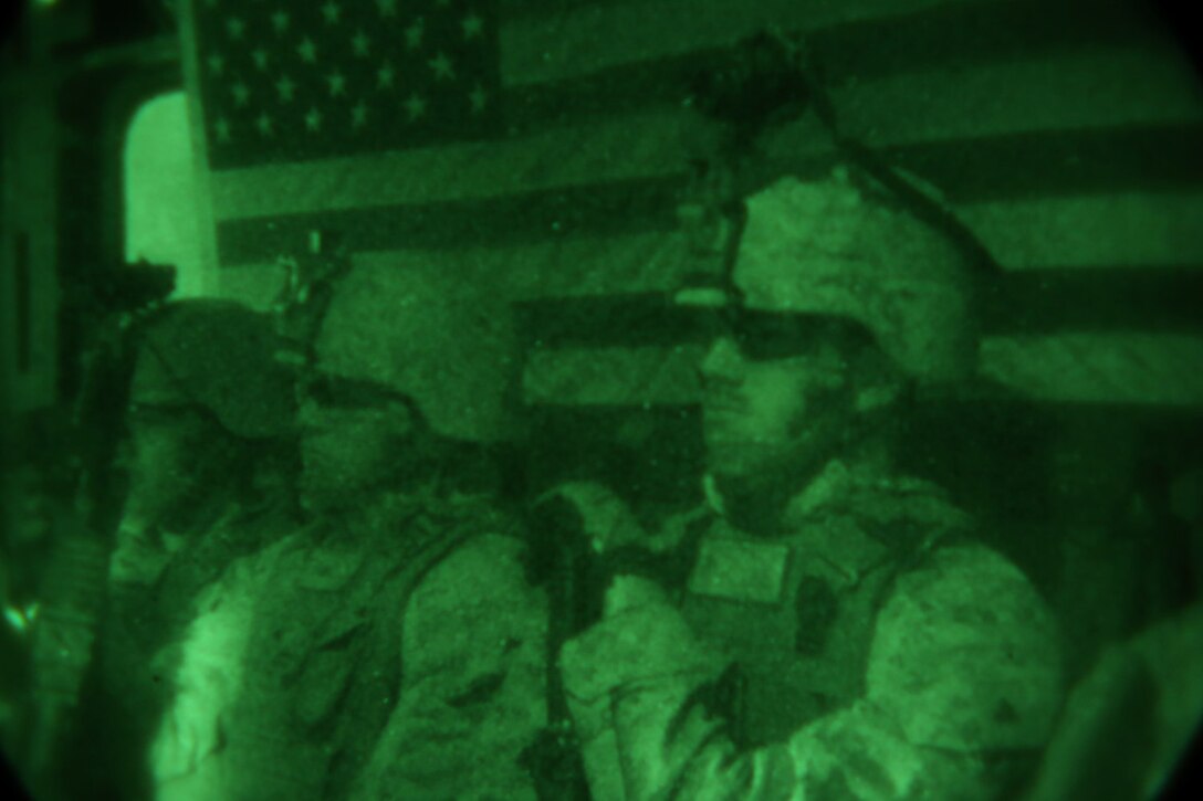 Corporal Martin Eadie, right, assault team leader, Bravo Company, 1st Battalion, 7th Marine Regiment, and a native of Fort Worth, Texas, waits anxiously inside a CH-53E Super Stallion while being transported to an objective during a mission in Helmand province, Afghanistan, May 15, 2014. The company operated in Larr Village for two days to establish a presence and to disrupt enemy fighters. Throughout the mission the infantrymen conducted several patrols within the village and discovered hazardous materials which could be used to create improvised explosive devices.