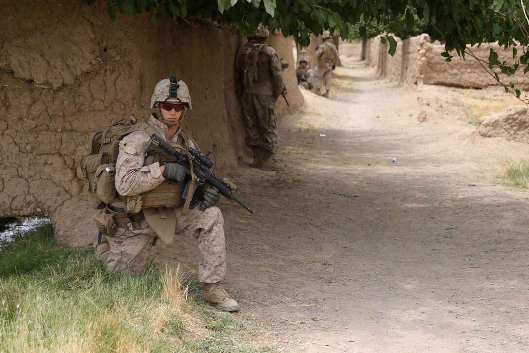 Corporal Cody Evans, squad leader, Bravo Company, 1st Battalion, 7th Marine Regiment, and a native of Yadkinville, North Carolina, provides security as Marines return to a patrol base during a mission in Helmand province, Afghanistan, May 15, 2014. The company operated in Larr Village for two days to establish a presence and to disrupt enemy fighters. Throughout the mission the infantrymen conducted several patrols within the village and discovered hazardous materials which could be used to create improvised explosive devices.