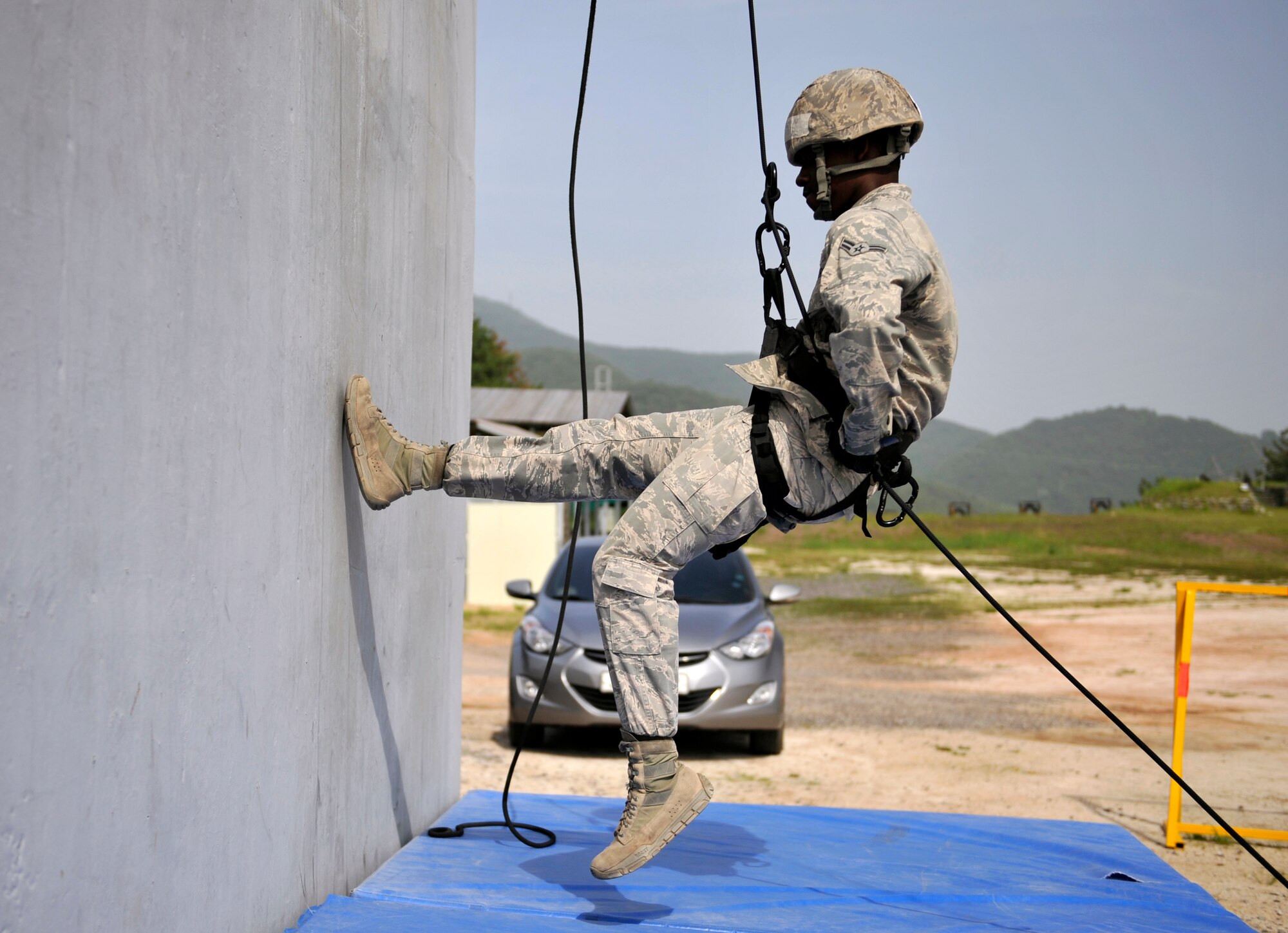Airman 1st Class Christopher Perry, 51st Security Forces Squadron, finishes repelling down the side of a training building during the Republic of Korea Ranger Qualification Course on Jinju Air Base, ROK, May 27, 2014. There were 32 ROK air force airmen and 15 U.S. Air Force Airmen who participated in the course. (U.S. Air Force photo/Senior Airman David Owsianka)