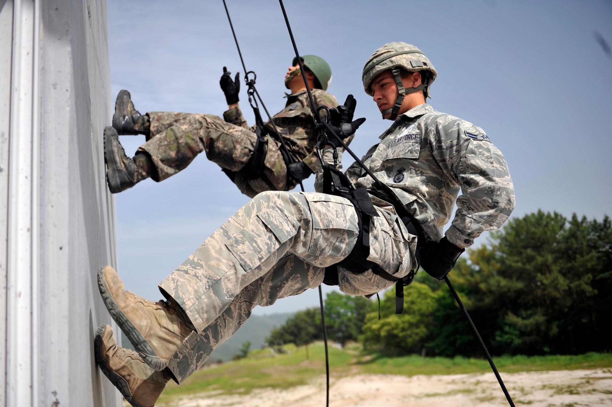 Airmen from the Republic of Korea air force and U.S. Air Force 51st Security Forces Squadron repel down the side of a training building during the Republic of Korea Ranger Qualification Course on Jinju Air Base, ROK, May 27, 2014. The Airmen also completed multiple obstacle courses, learning practical skills from overcoming confined spaces to scaling tall structures and moving silently and tactfully across rooftops. (U.S. Air Force photo/Senior Airman David Owsianka)