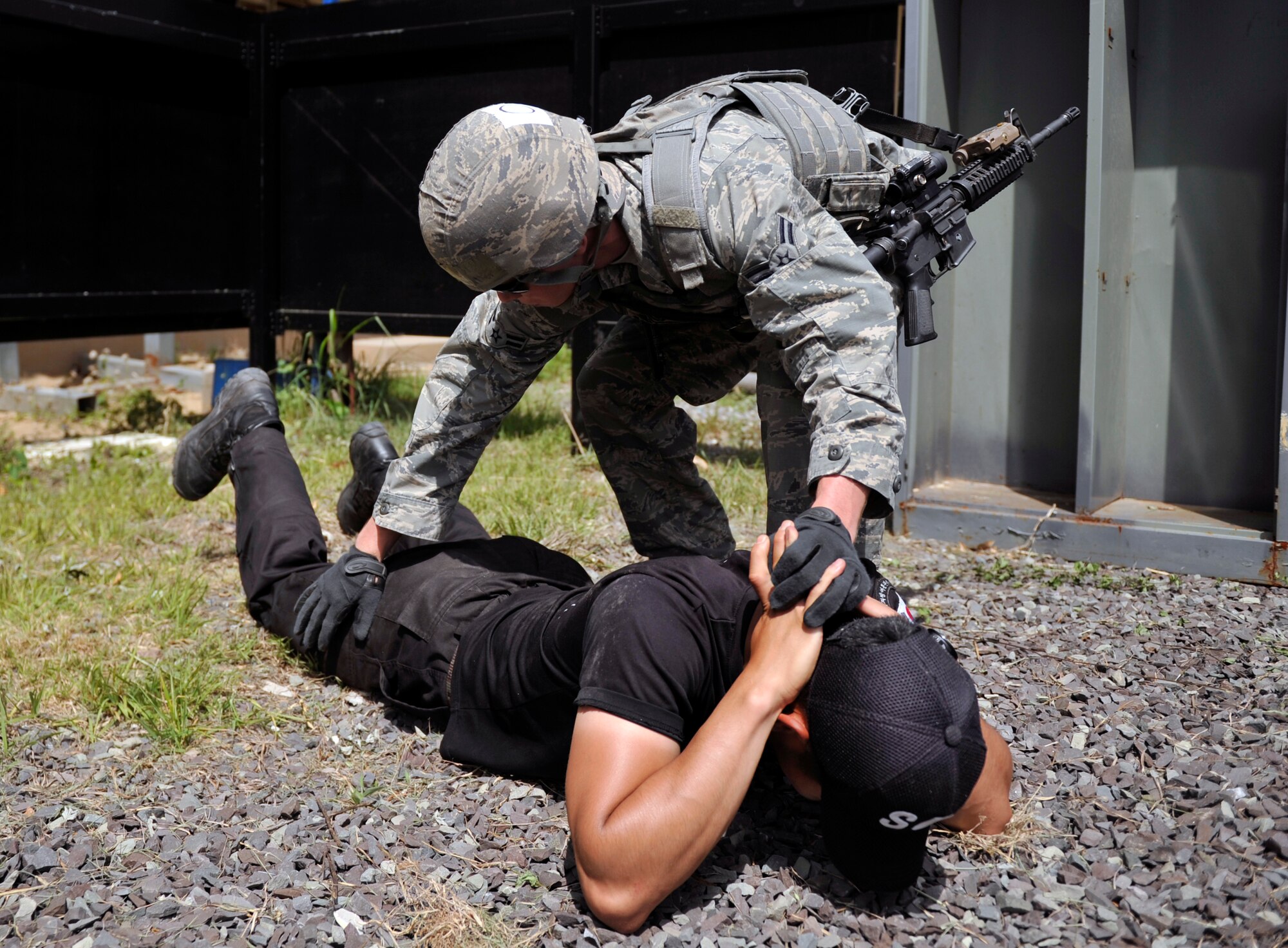 Airman 1st Class Brian Loughmiller, 51st Security Forces Squadron, pats down a Republic of Korea air force airman acting as a hostage in a hostage rescue scenario during the ROK Ranger Qualification Course on Jinju Air Base, ROK, May 27, 2014. Participants fired blanks from the same weapons used during daily operations to help add realism to the scenarios. (U.S. Air Force photo/Senior Airman David Owsianka)