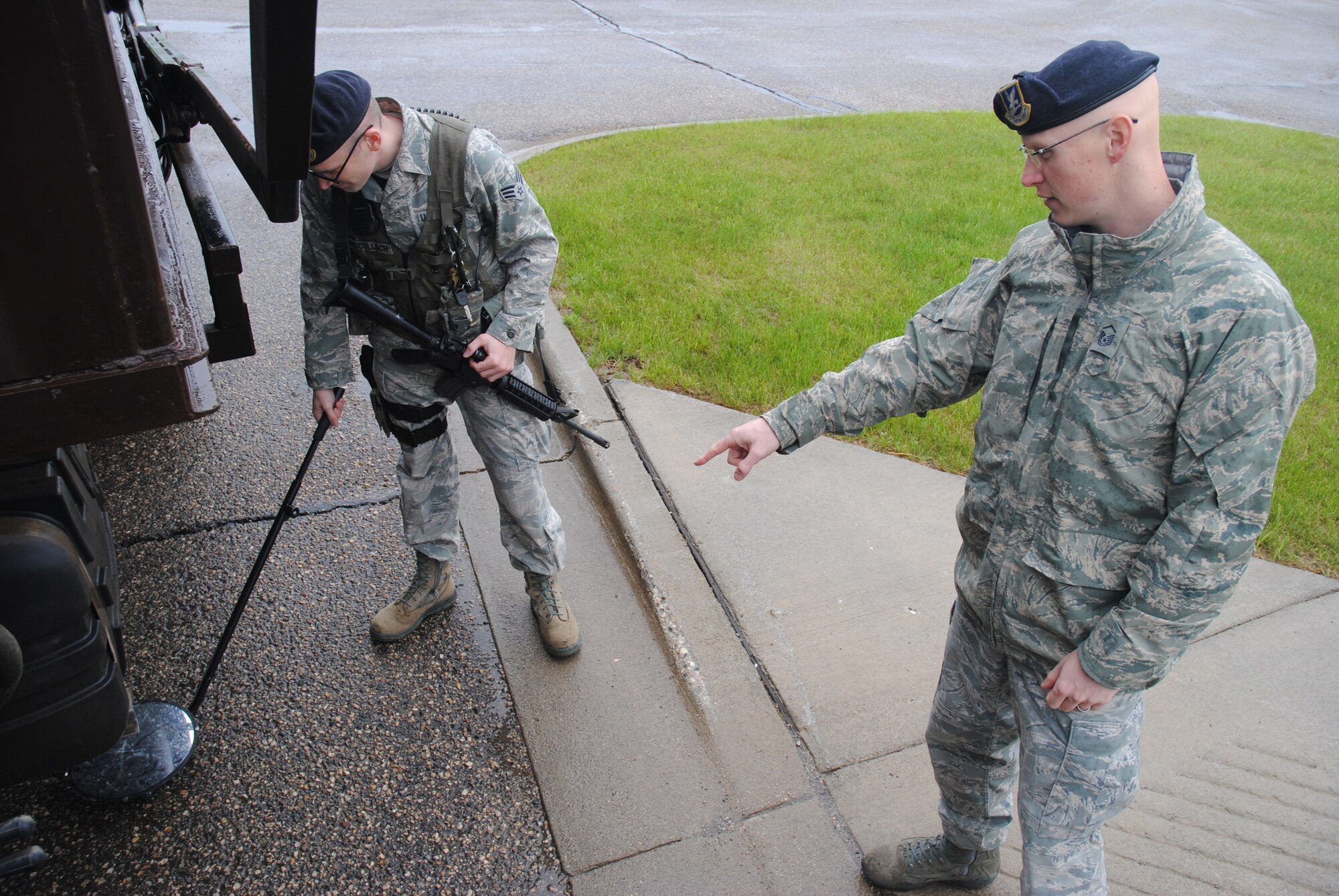 Master Sgt. Shane M. Sudman, instructs Senior Airman Matthew McCulloch to roll the mirror more towards the center of a commercial truck during a vehicle inspection at the main gate of Cavalier Air Force Station, N.D., on June 2, 2014. As the superintendent of security forces for the 10th Space Warning Squadron, Sudman is in charge of security operations for the installation. Sudman reinforces the importance of attention to detail especially when base security is involved. (U.S. Air Force photo/Staff Sgt. Luis Loza Gutierrez)
