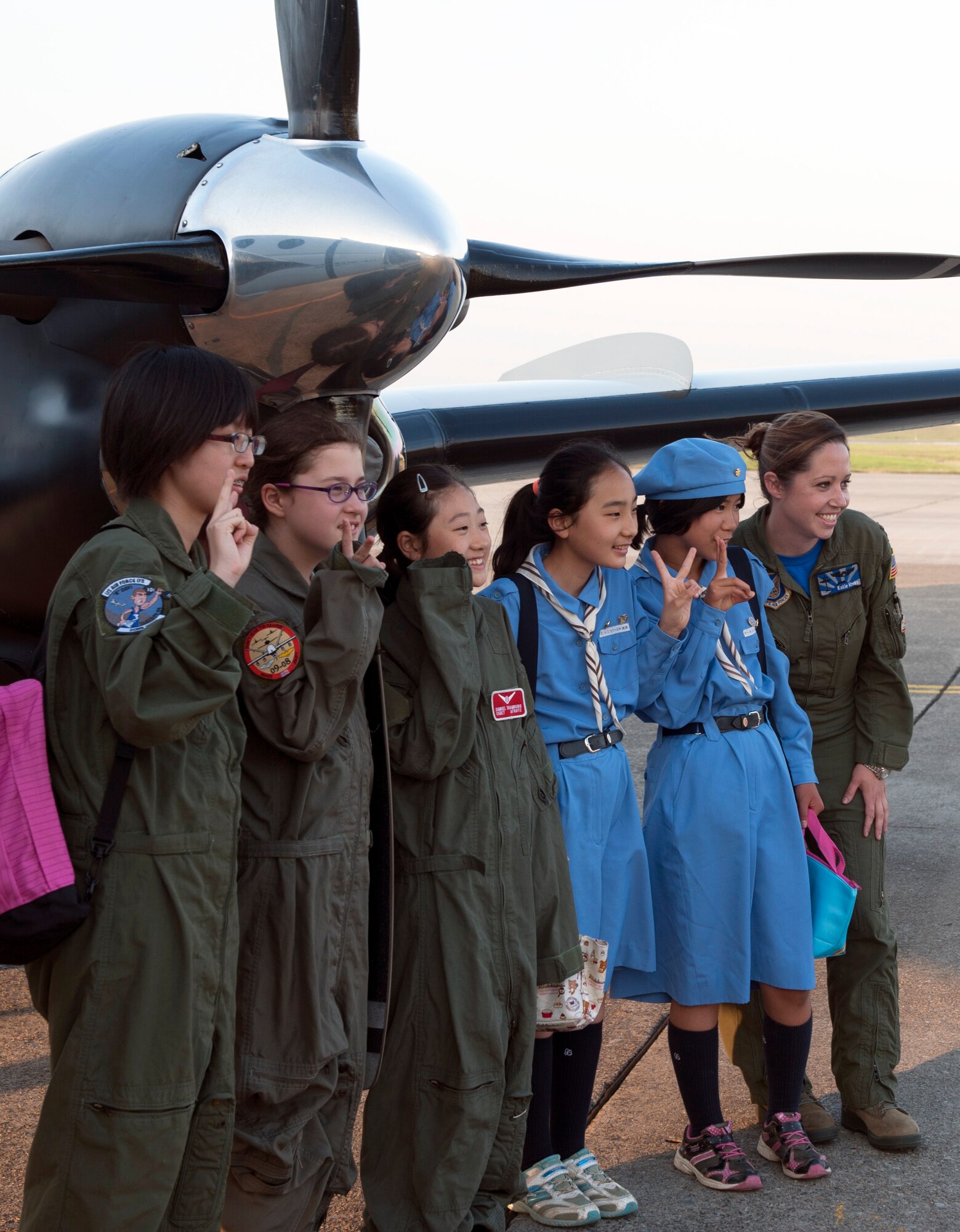 Japanese Girl Scouts take a photograph with Capt. Katie Weeks, 459th Airlift Squadron flight commander, during Military SHeroes Day May 30, 2014, at Yokota Air Base, Japan. Girl Scouts from Yokota and the Kanto Plains joined together for the event. (U.S. Air Force photo by Senior Airman Desiree Economides)