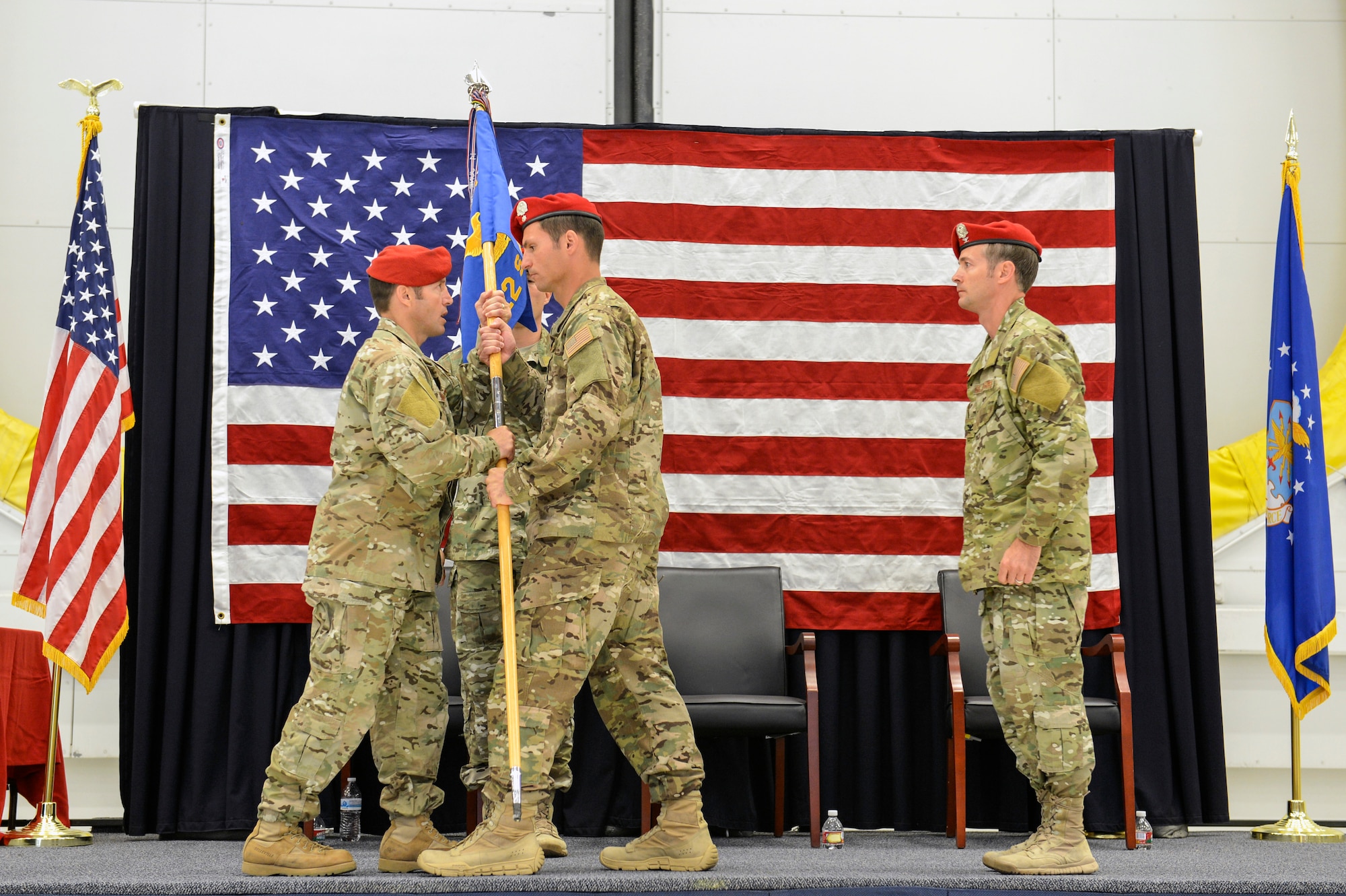 The 22nd Special Tactics Squadron guide-on is passed to Lt. Col. Michael Evancic (center), incoming 22nd STS commander by presiding officer Col. Kurt Buller (left), 720th Special Tactics Group commander during a change of command ceremony June 3, 2014, at Joint Base Lewis-McChord, Wash. Changes of command are a military tradition representing the transfer of responsibilities from the outgoing official to the incoming official. (U.S. Air Force photo/Staff Sgt. Russ Jackson)