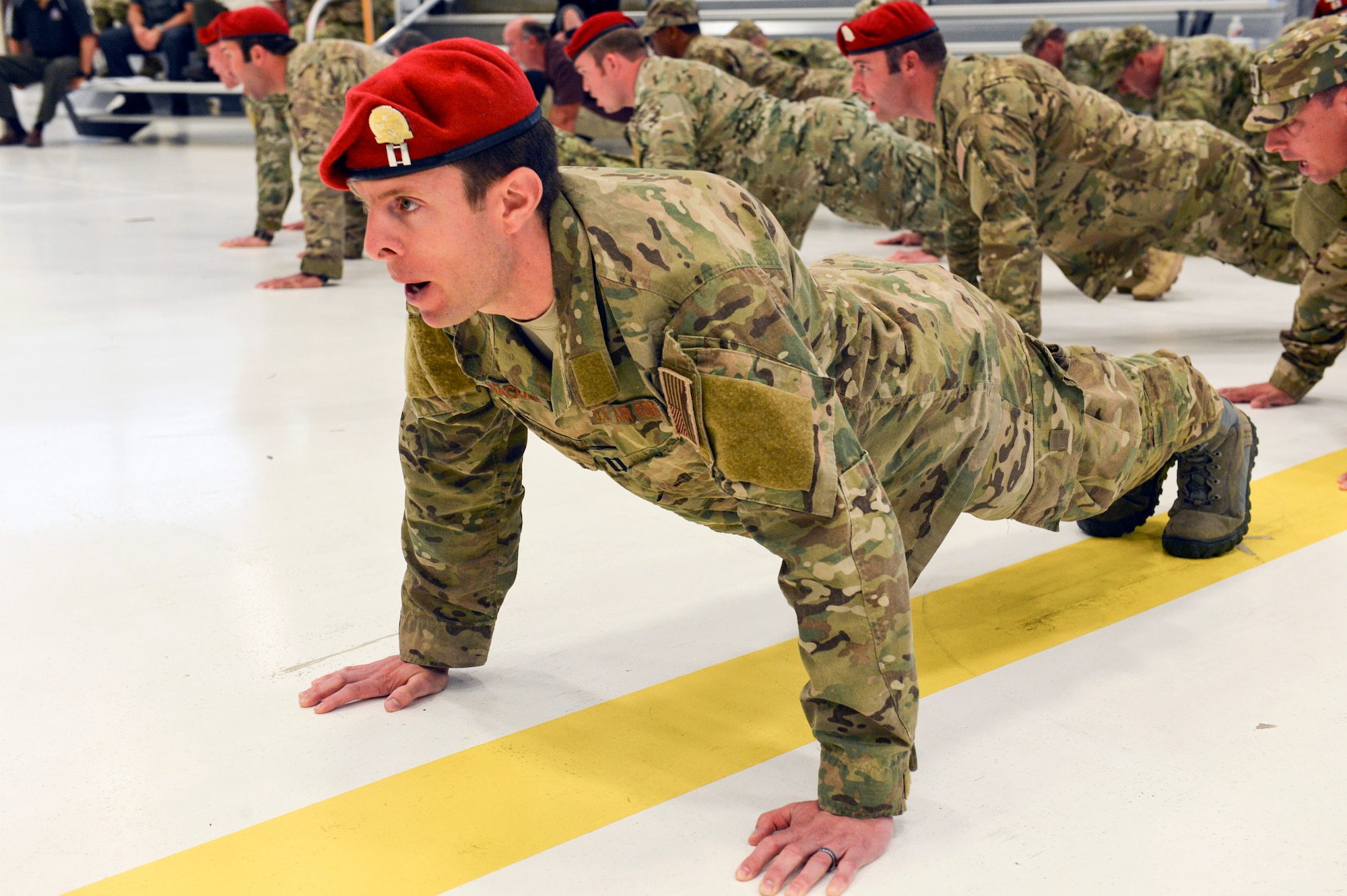 Capt. Garrett Ianacone, 22nd Special Tactics Squadron director of operations, performs memorial push-ups with his Airmen during the change of command ceremony, June 3, 2014, at Joint Base Lewis-McChord, Wash. Col. Thad Allen, outgoing 22nd STS commander, gave his final order and led the Airmen in the push-ups before he relinquished his command of the squadron. (U.S. Air Force photo/Staff Sgt. Russ Jackson)